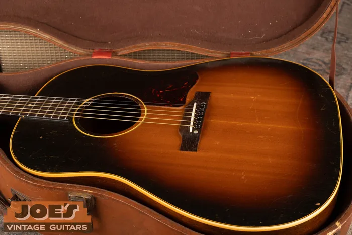 A 1950s Gibson J-45 in its original case. Sunburst finish