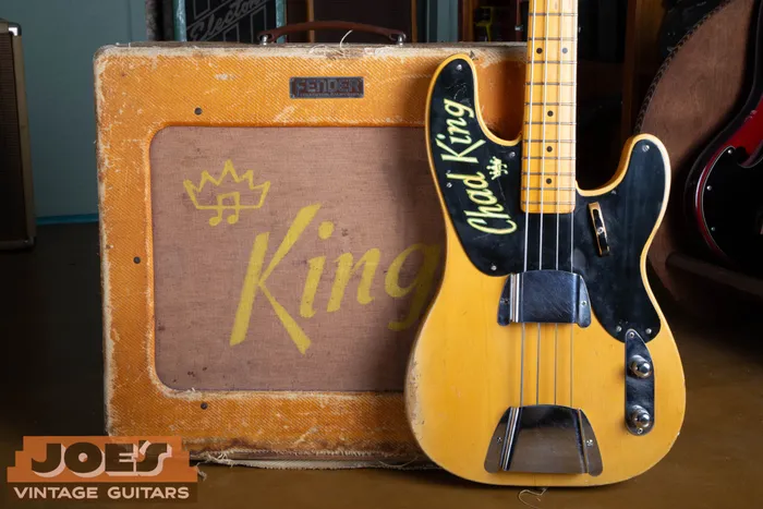A stunning lifestyle photograph featuring an investment-grade 1952 Fender Precision Bass paired with a matching "TV Front" 1952 Fender Bassman amplifier. The bass features the original owner's name neatly hand-painted on the black phenolic pickguard, mirrored by the same personalized name on the amp's original linen grill cloth, a rare, documented piece of provenance linking these two instruments as a lifetime pair.