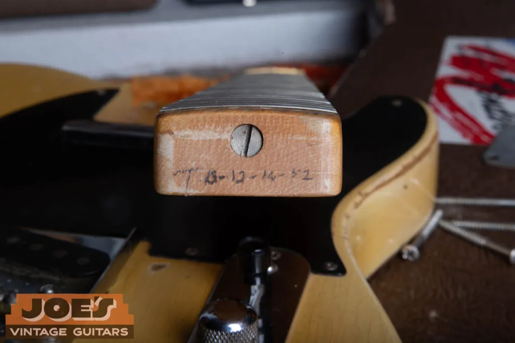 The neck heel of a 1952 Fender Telecaster showing the penciled date and the slot-head truss rod adjustment screw