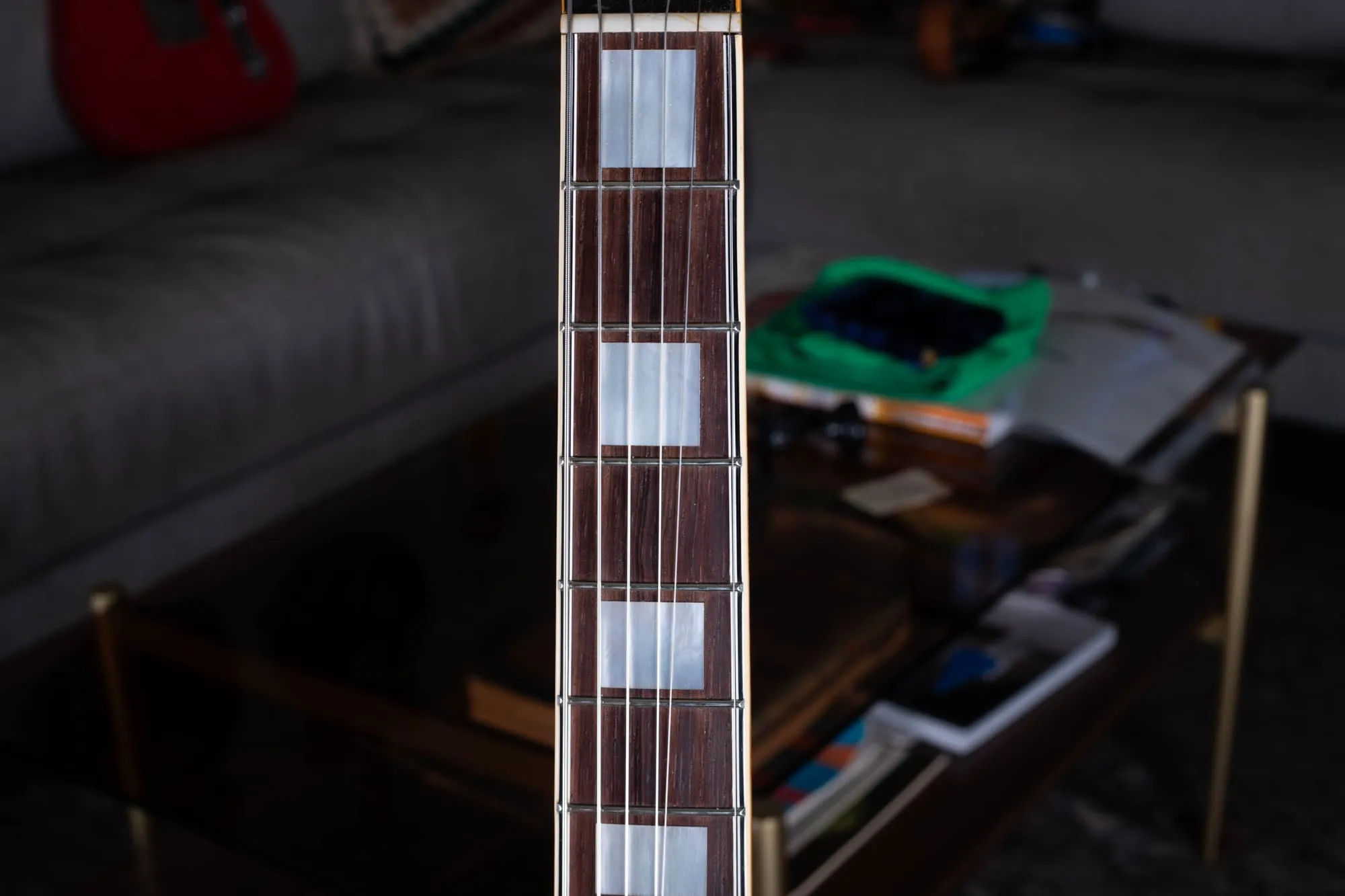 Bound rosewood fingerboard of a vintage Gibson ES-5 with large mother-of-pearl block inlays.