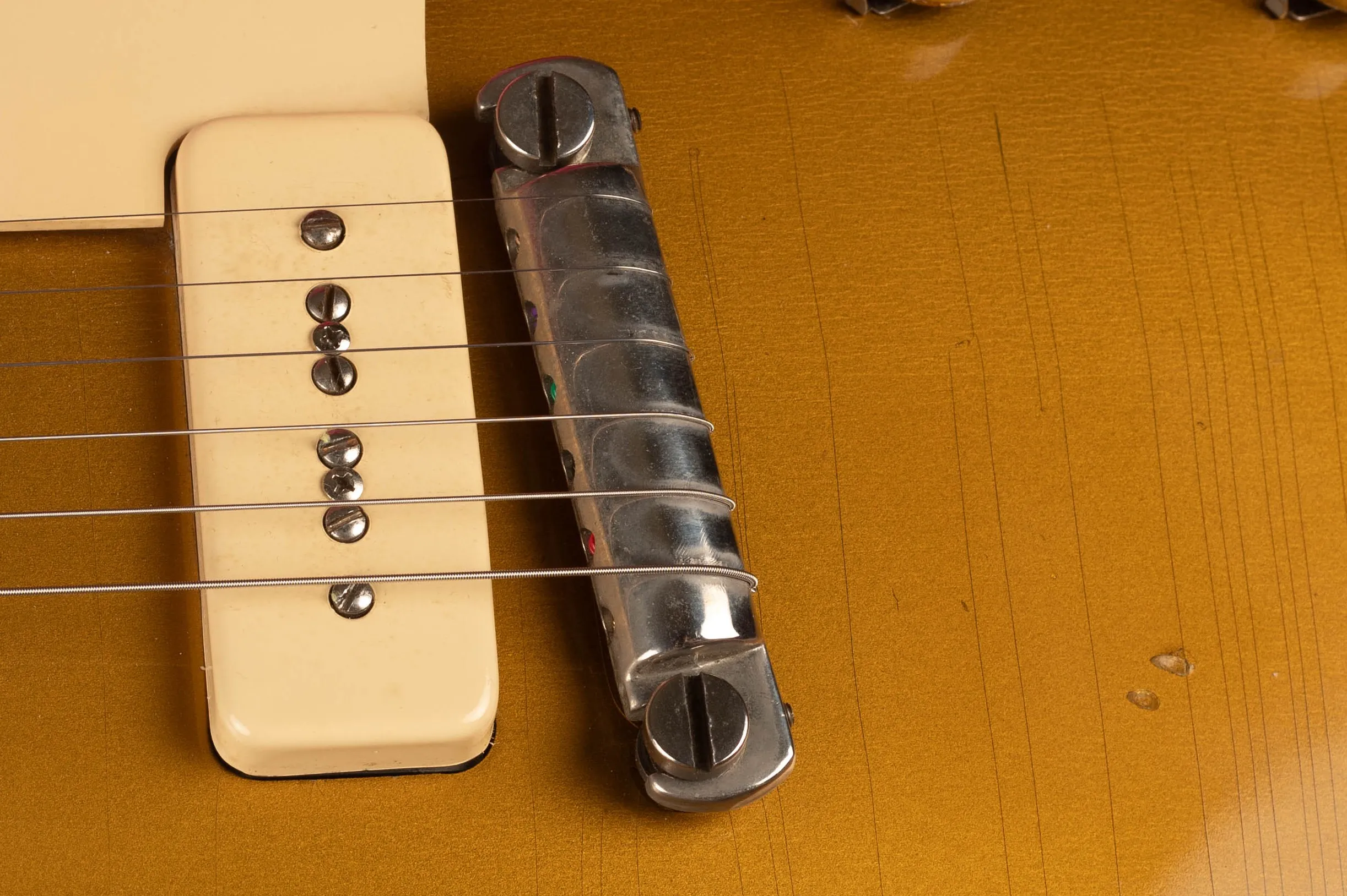 1954 Gibson Les Paul Goldtop wrap tail bridge close-up, nickel-plated stud bar bridge with threaded posts and original shorter bushings