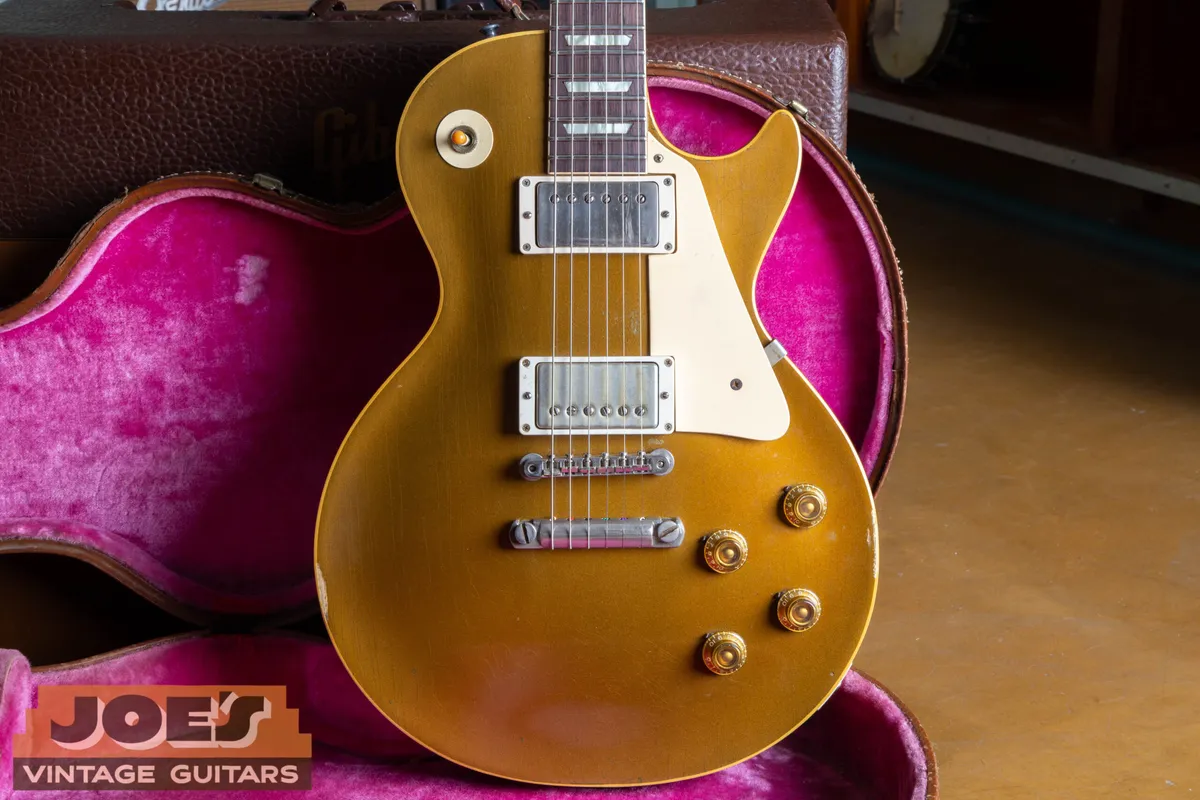 A detailed look at an original 1957 Gibson Les Paul Standard, highlighting the iconic bullion gold top and dual PAF humbucking pickups.