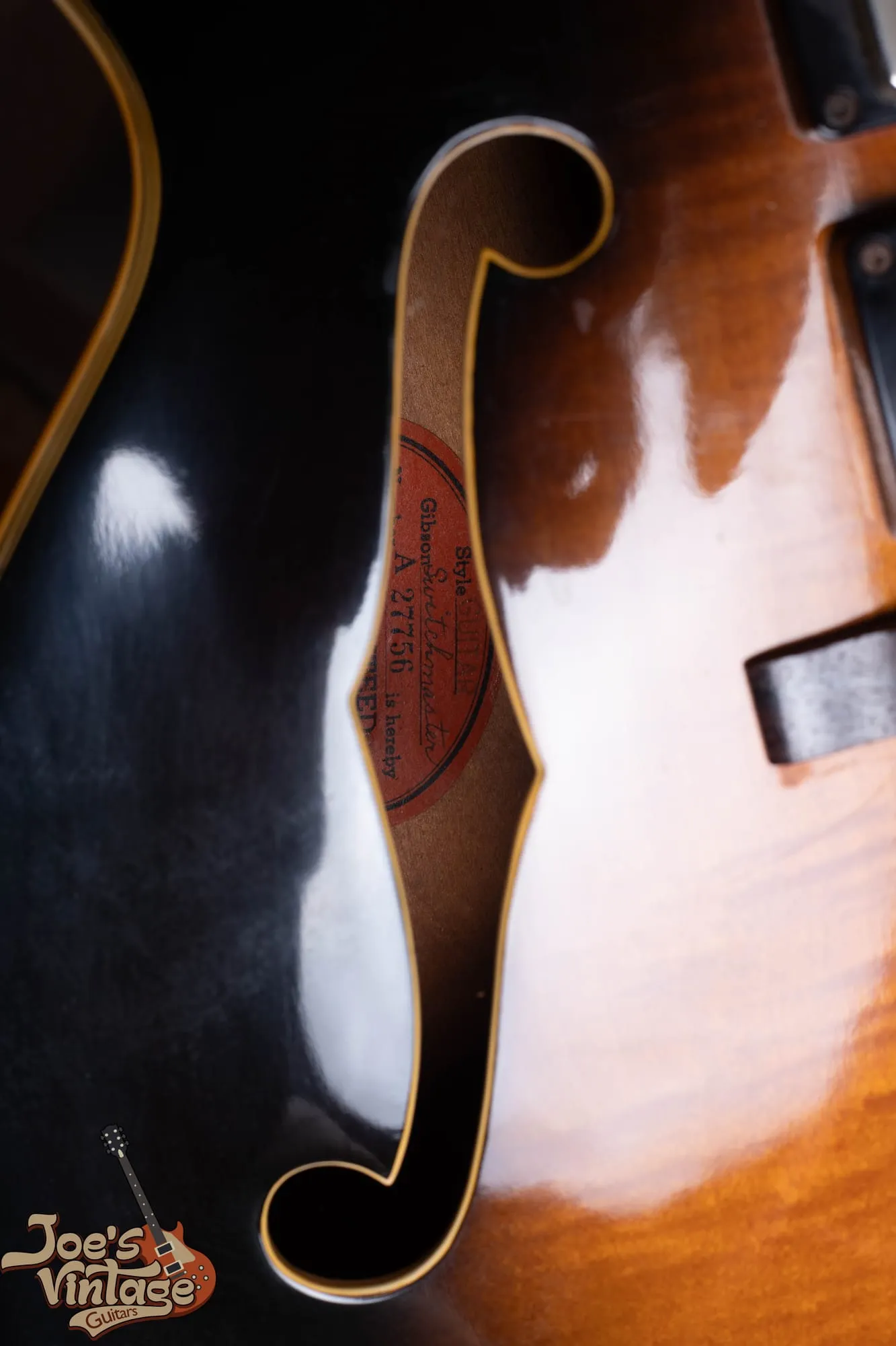 An orange oval Gibson guarantee label reading Gibson Switchmaster and serial number A-27756 inside a 1958 ES-5.