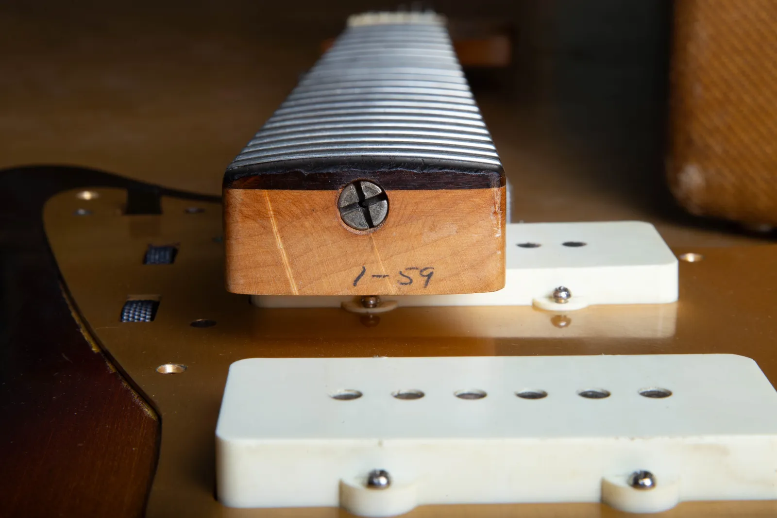 The neck heel of a 1959 Fender Jazzmaster with a pencil date reading 1-59 for January 1959, the neck lifted out of the body