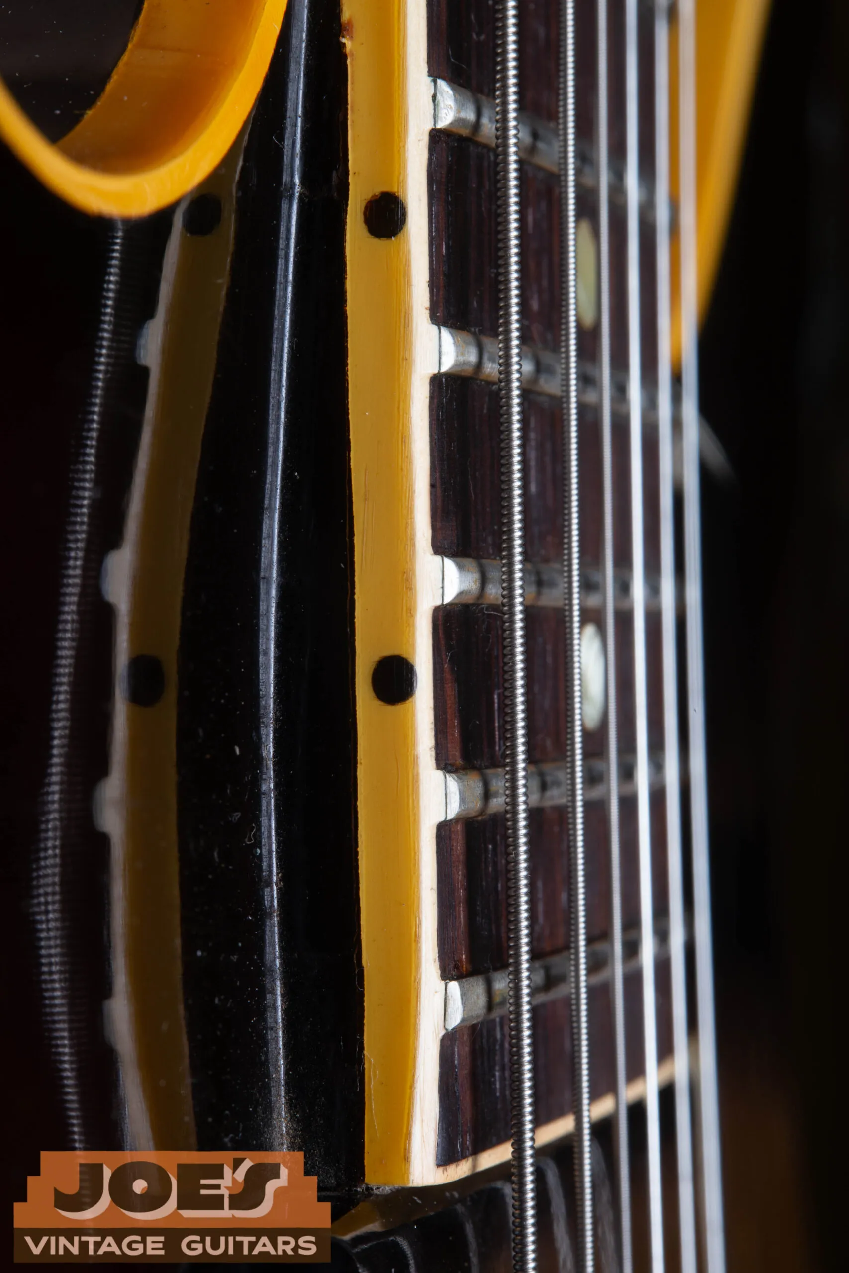 Fret nibs on the binding edge of a 1959 Gibson ES-330 fretboard, the binding extends above the fret ends creating a smooth edge