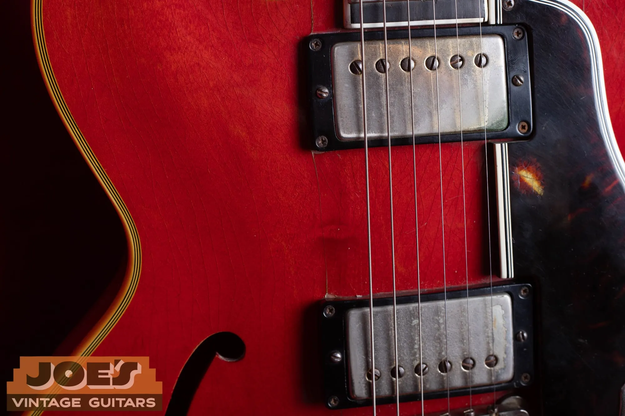Two gold-cover PAF humbuckers with the gold plating worn to bare nickel on a 1959 Gibson ES-355, with a tortoise pickguard and heavy finish checking.