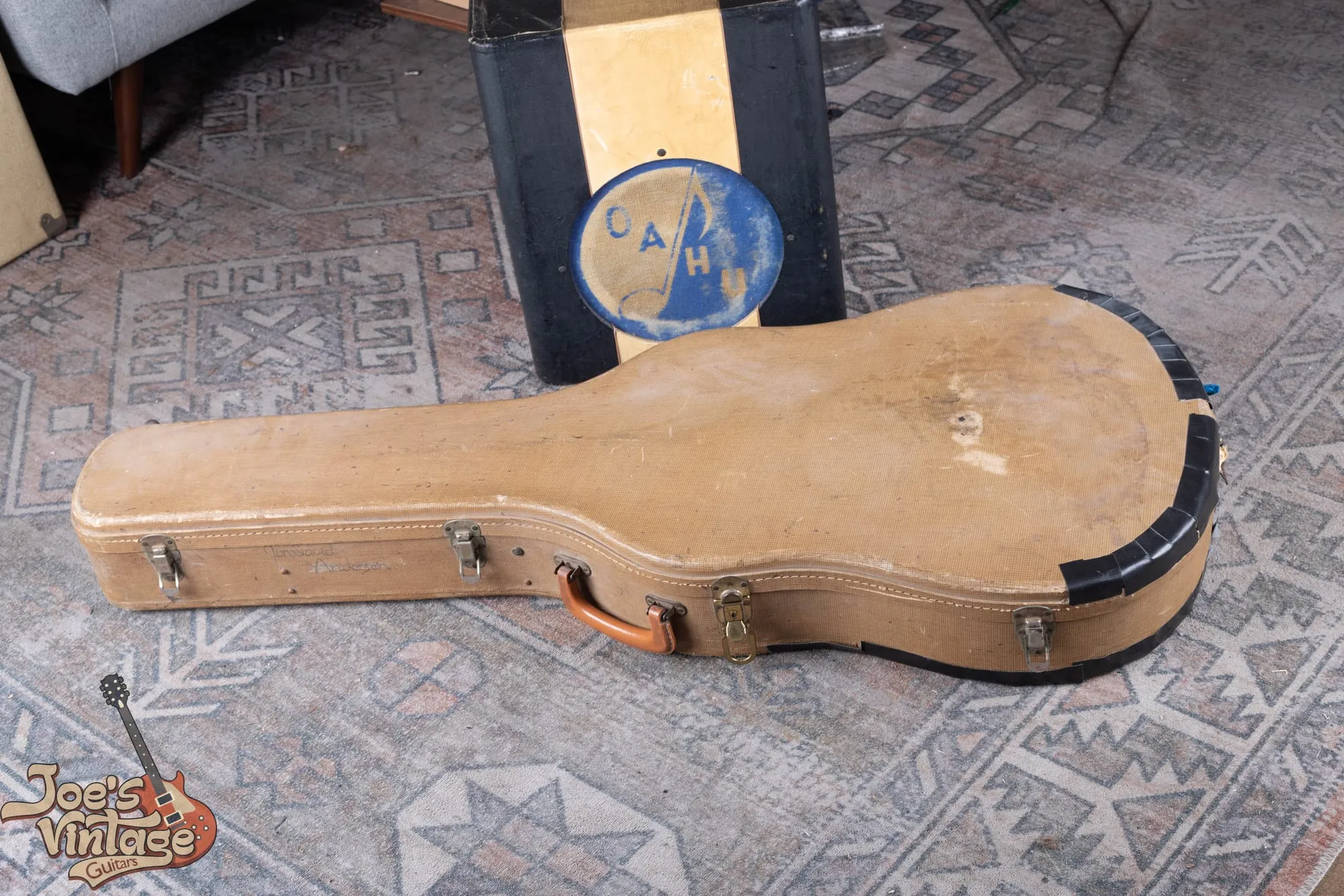 A 1961 Epiphone Sheraton in its original brown hardshell case with blue plush lining.