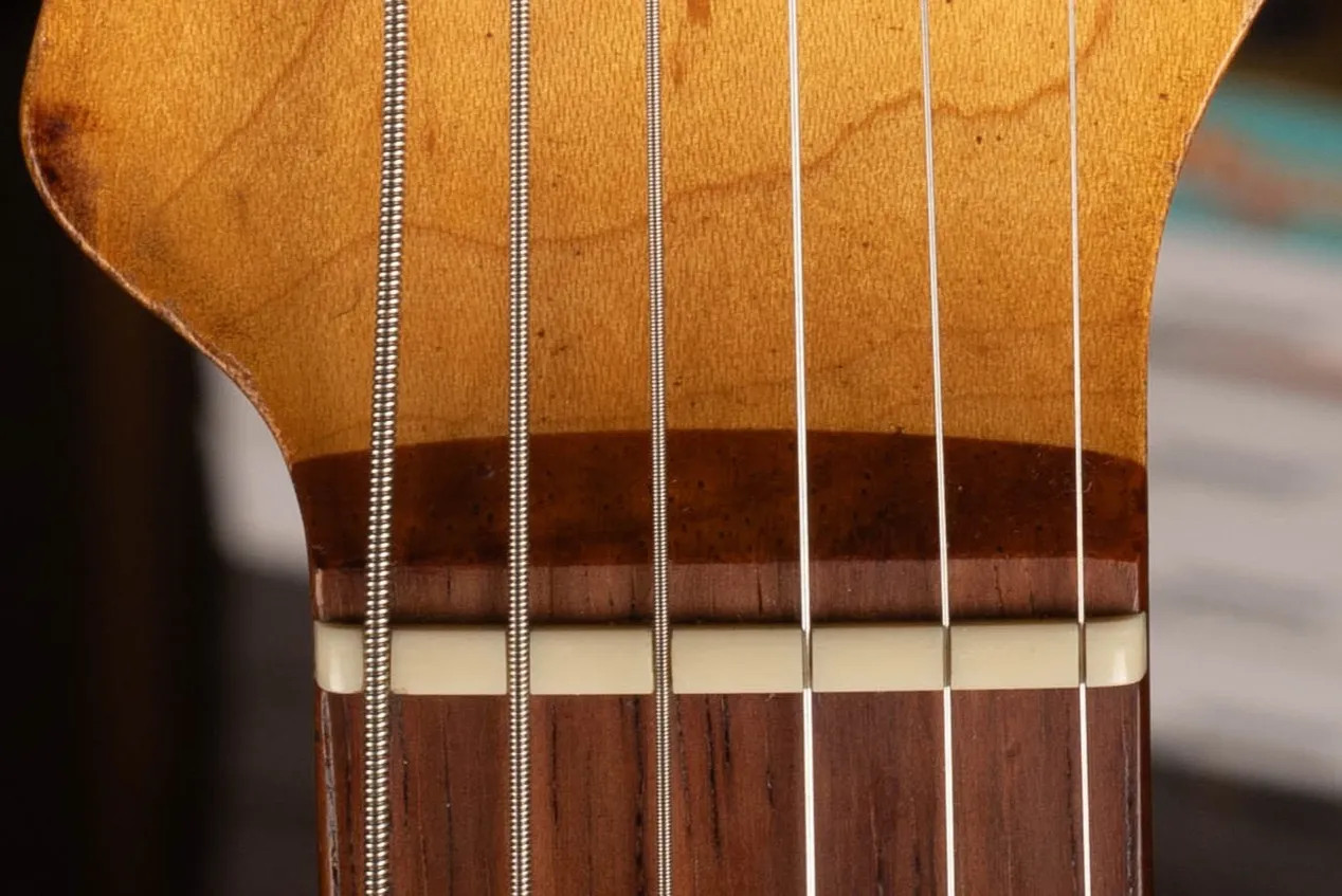 1962 Fender Stratocaster slab rosewood fingerboard nut area, approximately 4.8mm thick flat-bottom board showing deep rosewood depth at headstock end