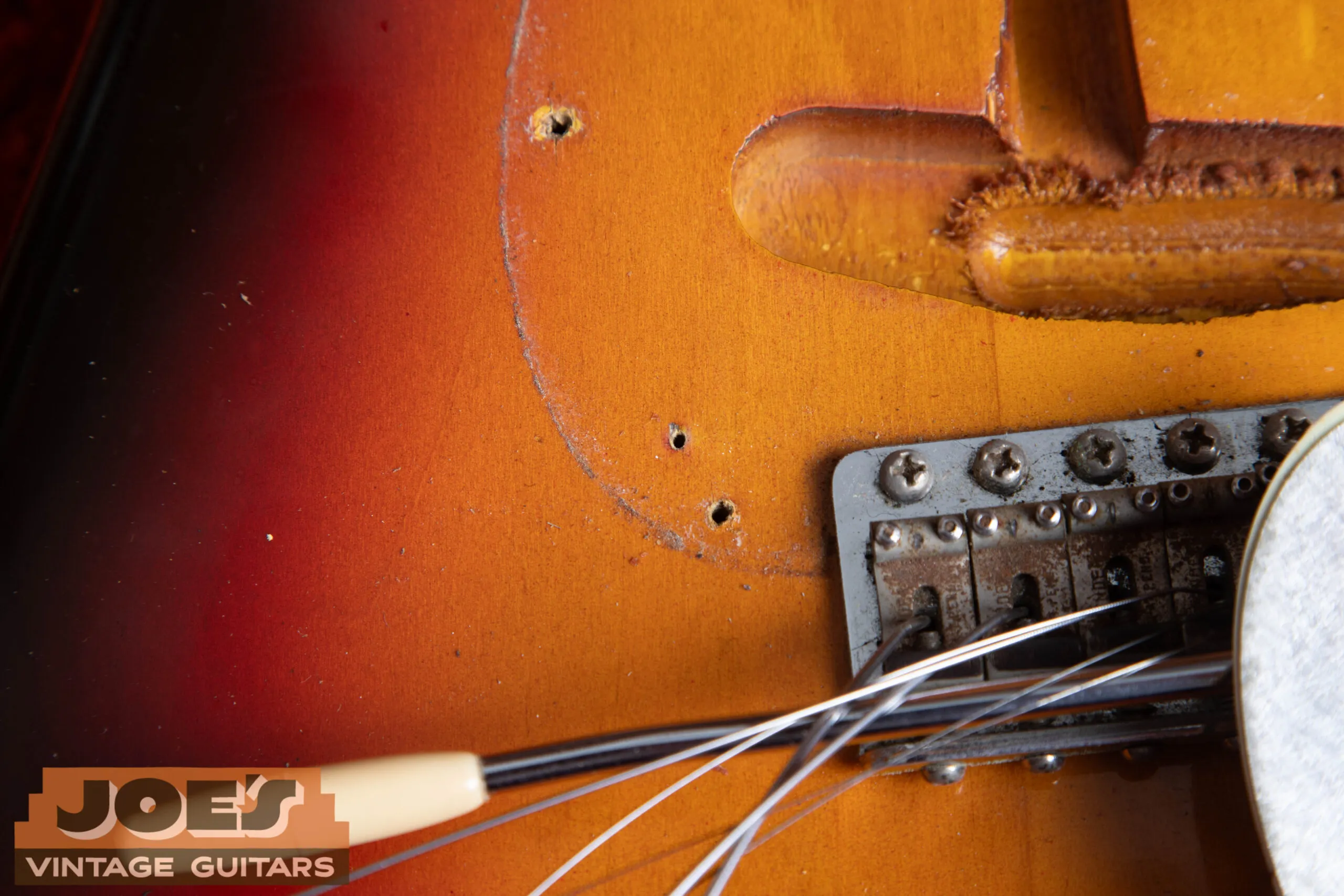 1962 Fender Stratocaster body face nail hole under pickguard area, finishing suspension point hidden beneath the pickguard on the body face
