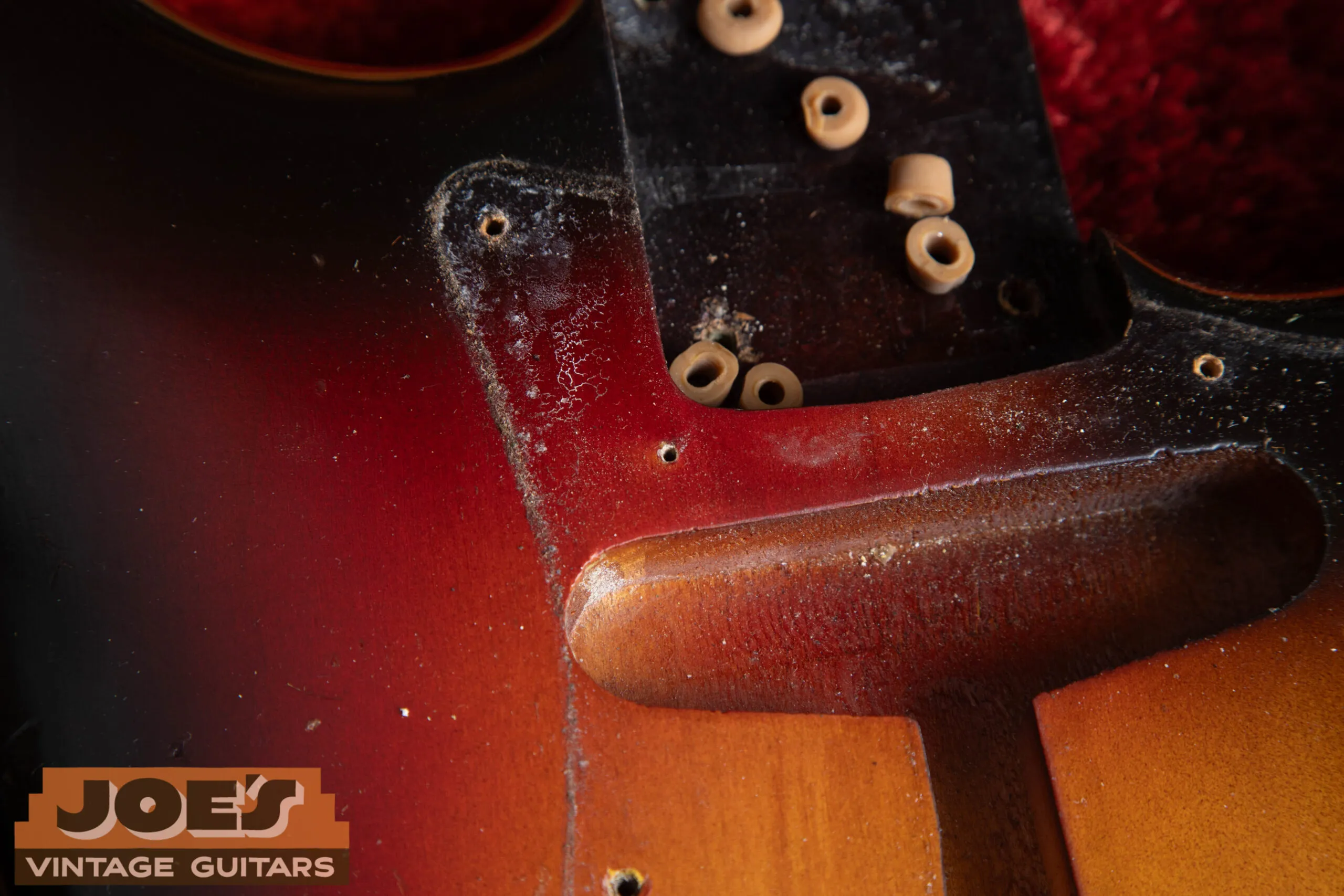 Second finishing nail hole on 1962 Fender Stratocaster body face, under pickguard, confirming original Fullerton body finishing method