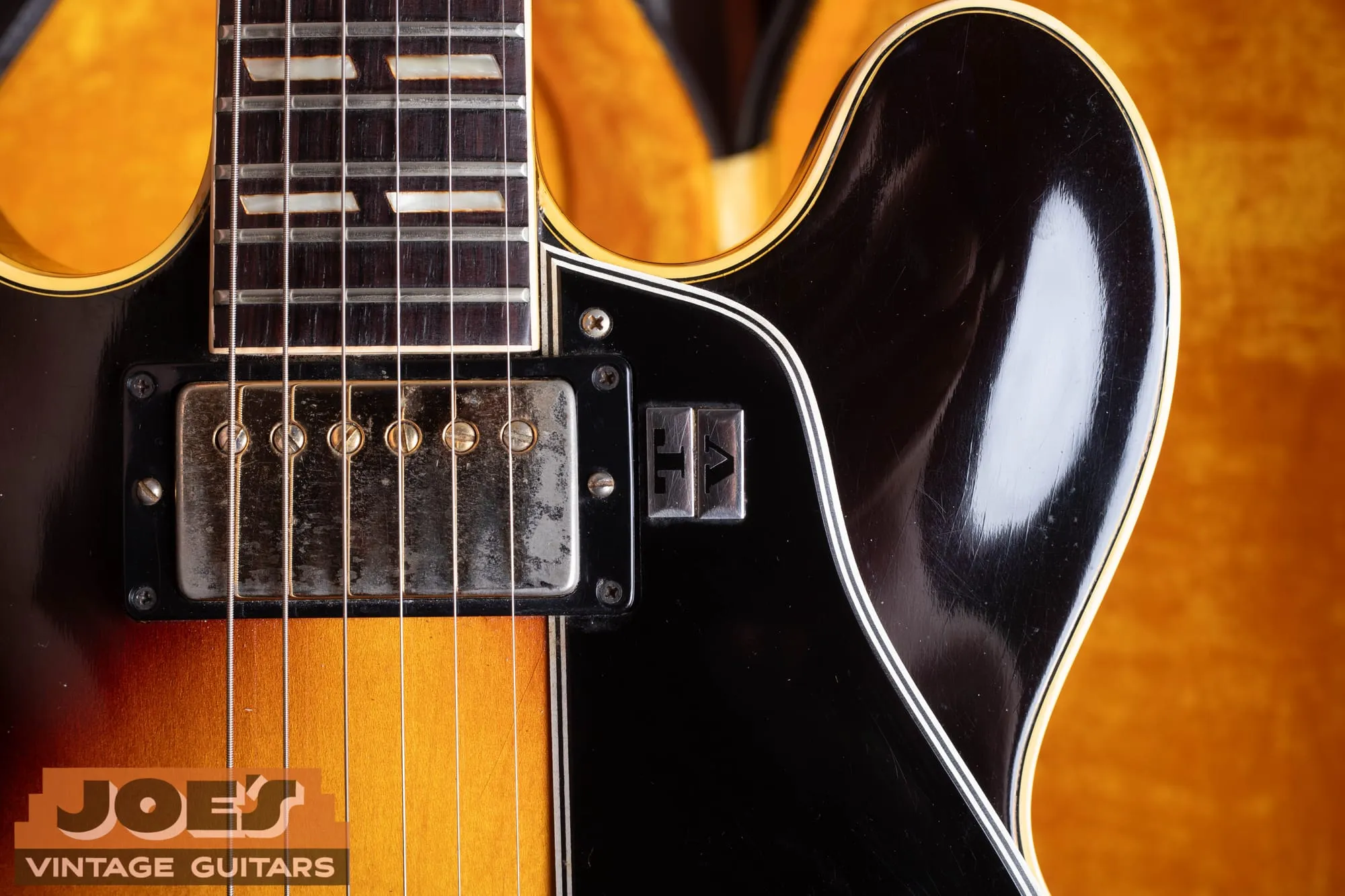 Close-up of a gold-covered humbucker and the neck join on a 1963 Gibson ES-345 in sunburst.