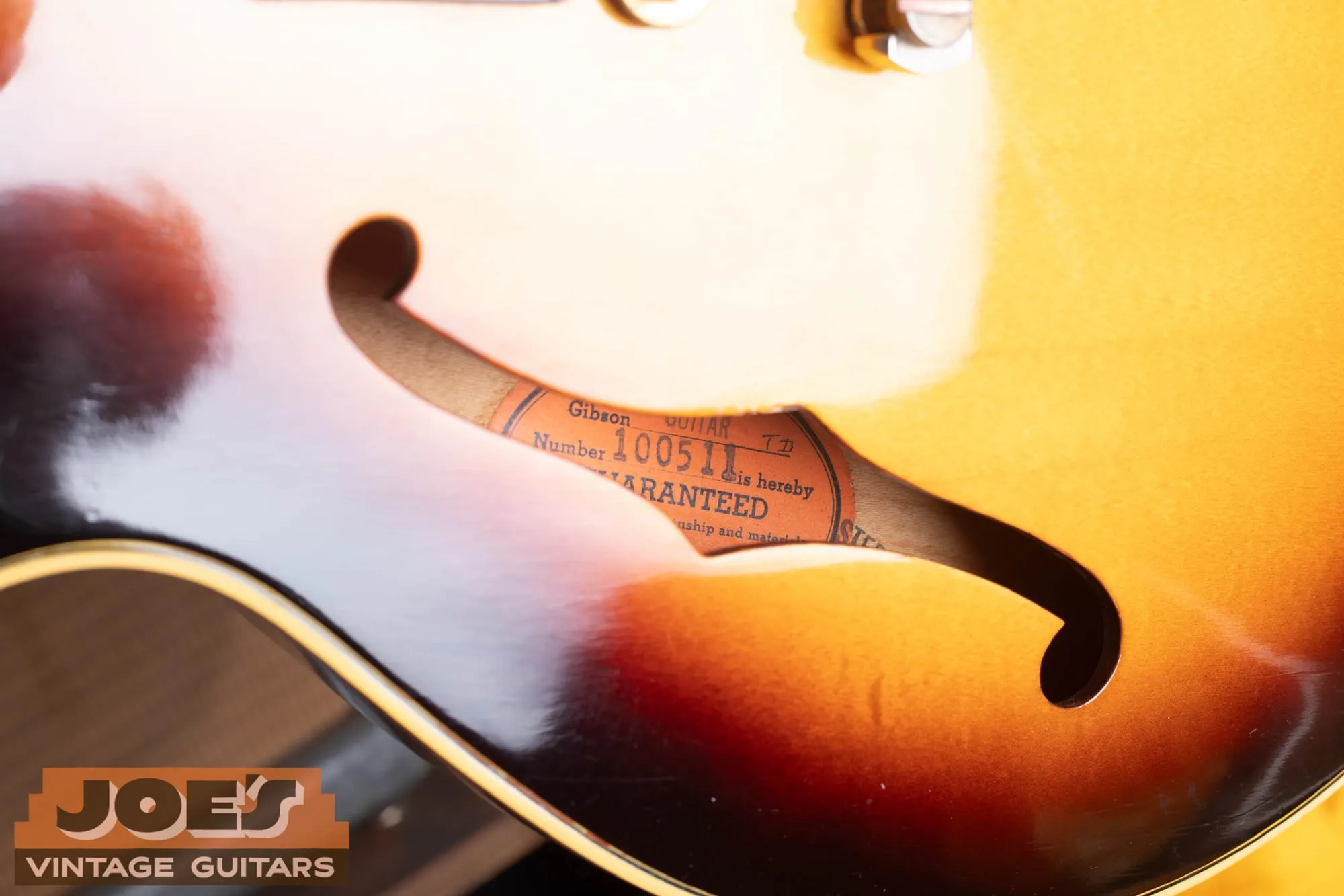 The Gibson guarantee label seen through the f-hole of a 1963 ES-345, reading model ES-345TD and number 100511.