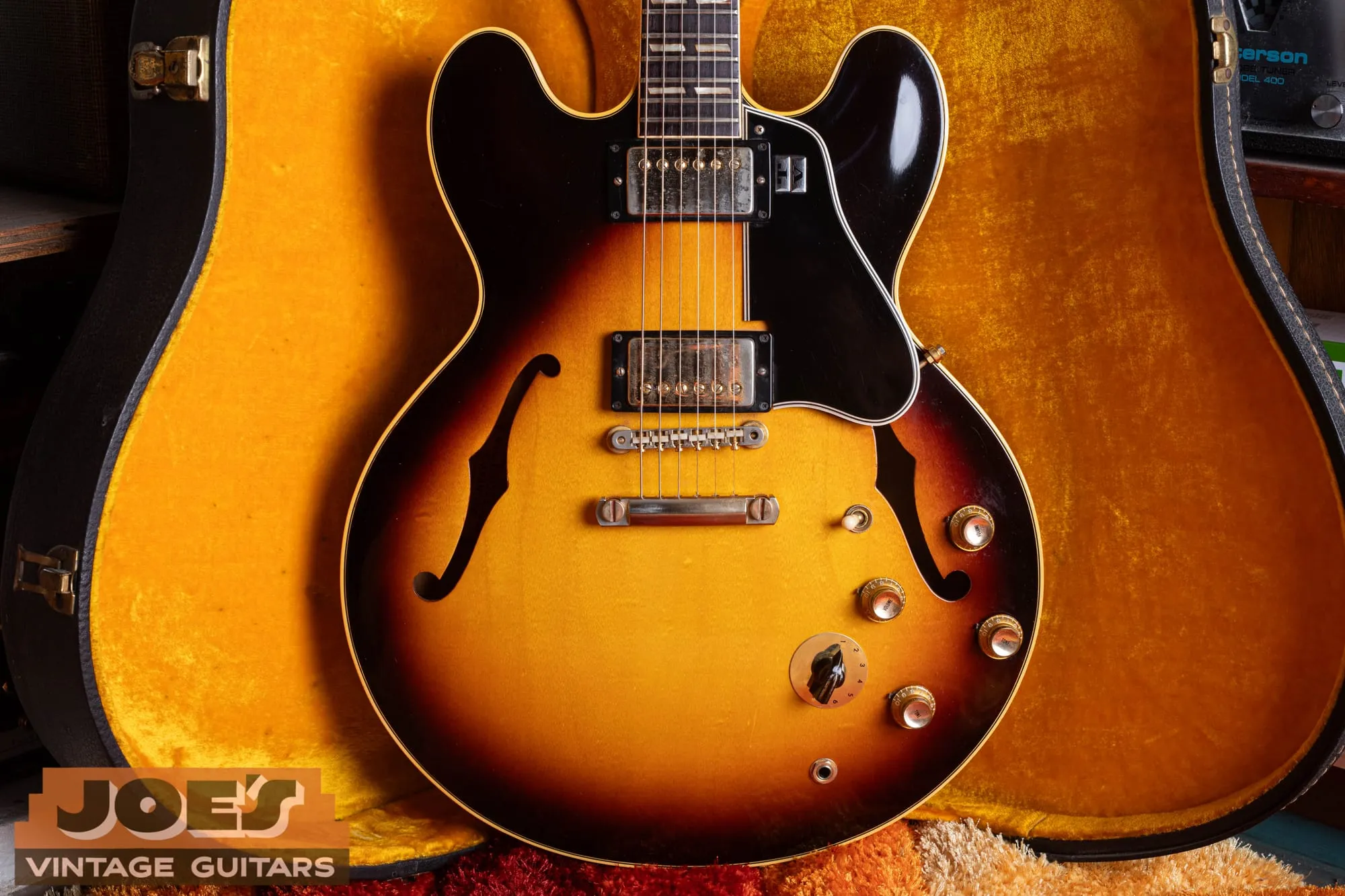 A 1963 Gibson ES-345TD in sunburst finish shown from the front in its brown case with gold plush lining.