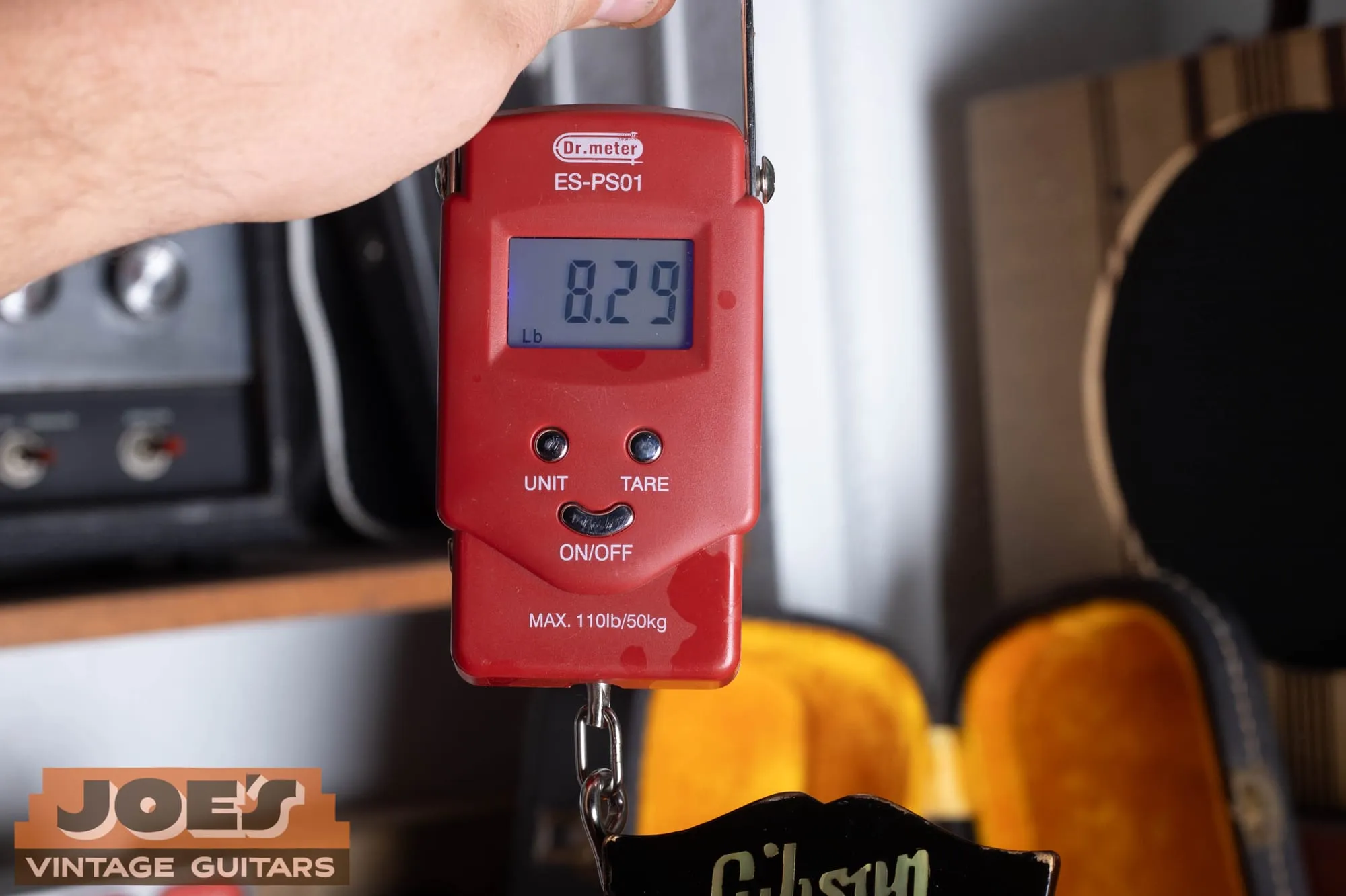 A digital scale showing a weight of 8.29 pounds for a 1963 Gibson ES-345.