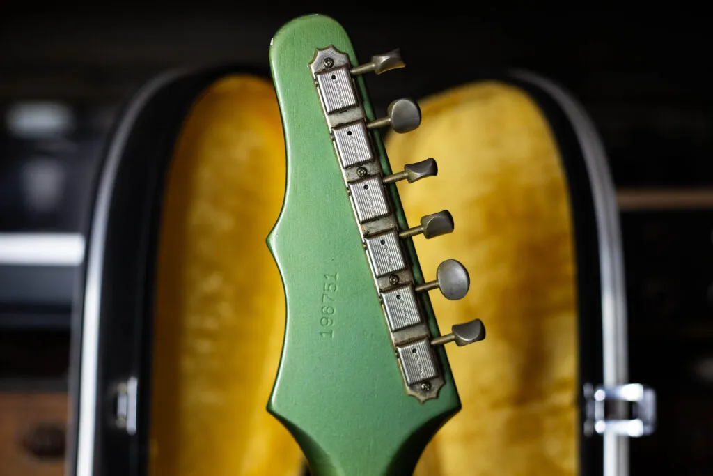 Rear view of a 1964 Epiphone Crestwood asymmetrical “Batwing” headstock, showing the six-in-line Kluson tuners and the custom color finish.