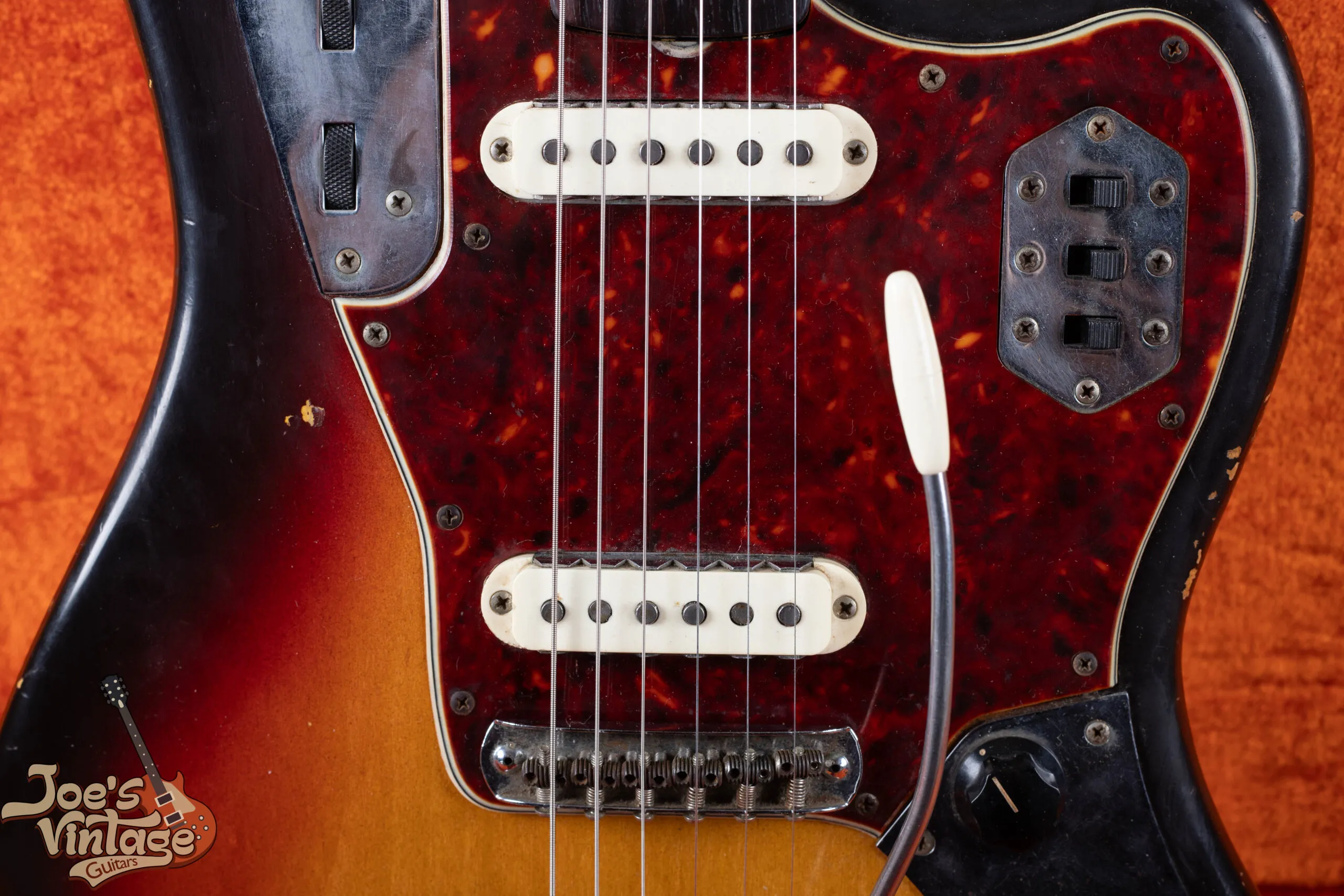 Pair of single coil pickups on a 1964 Fender Jaguar showing the notched metal claw shielding