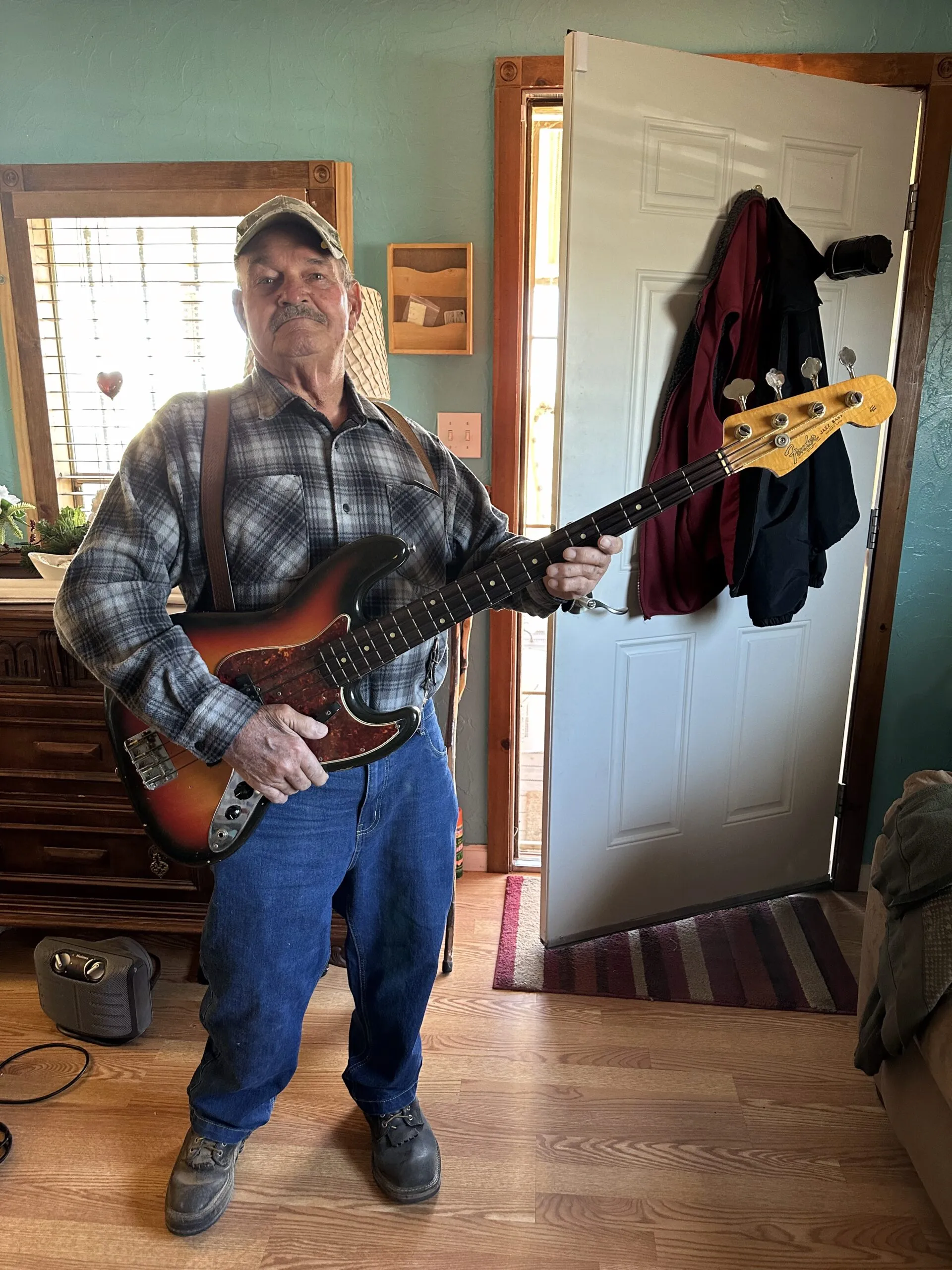 The original owner of a 1964 Fender Jazz Bass posing for a photo after selling to Joe's Vintage Guitars