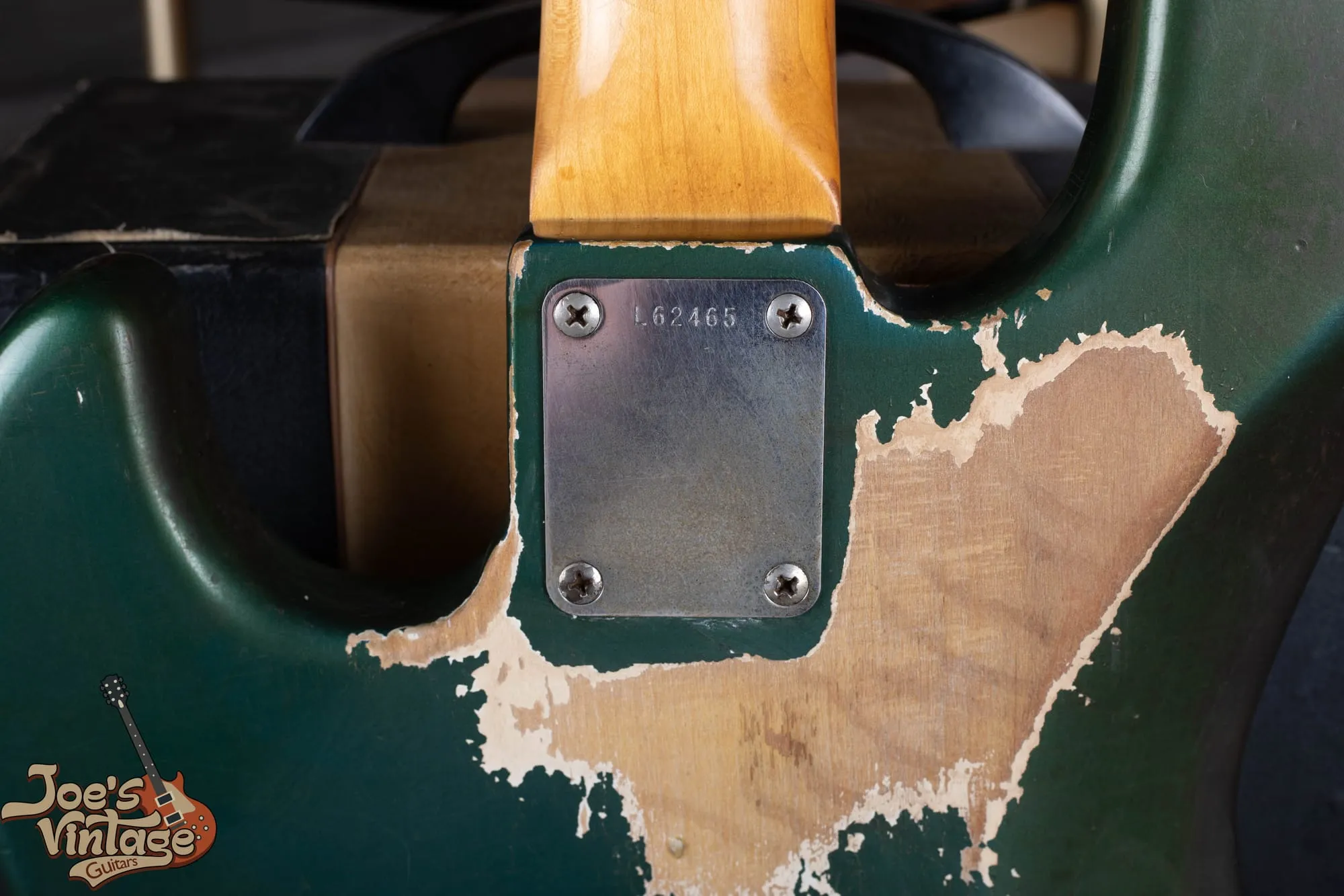 Back of a 1966 Fender Jazz Bass in Lake Placid Blue showing heavy belt wear where the blue has worn through to reveal a white undercoat beneath.