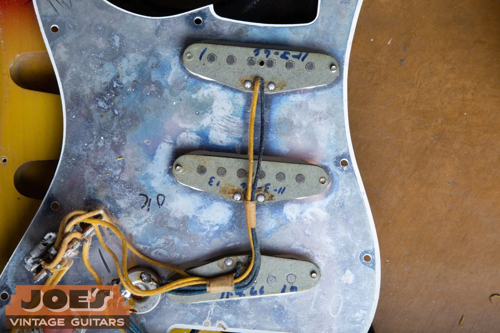 The underside of a 1966 Fender Stratocaster pickguard, its three pickups each dated on the base in November 1966