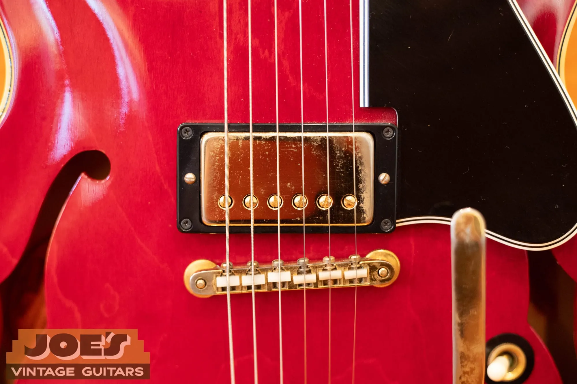 Close-up of the gold ABR-1 tune-o-matic bridge and gold-covered pickup on a 1966 Gibson ES-345 in cherry.