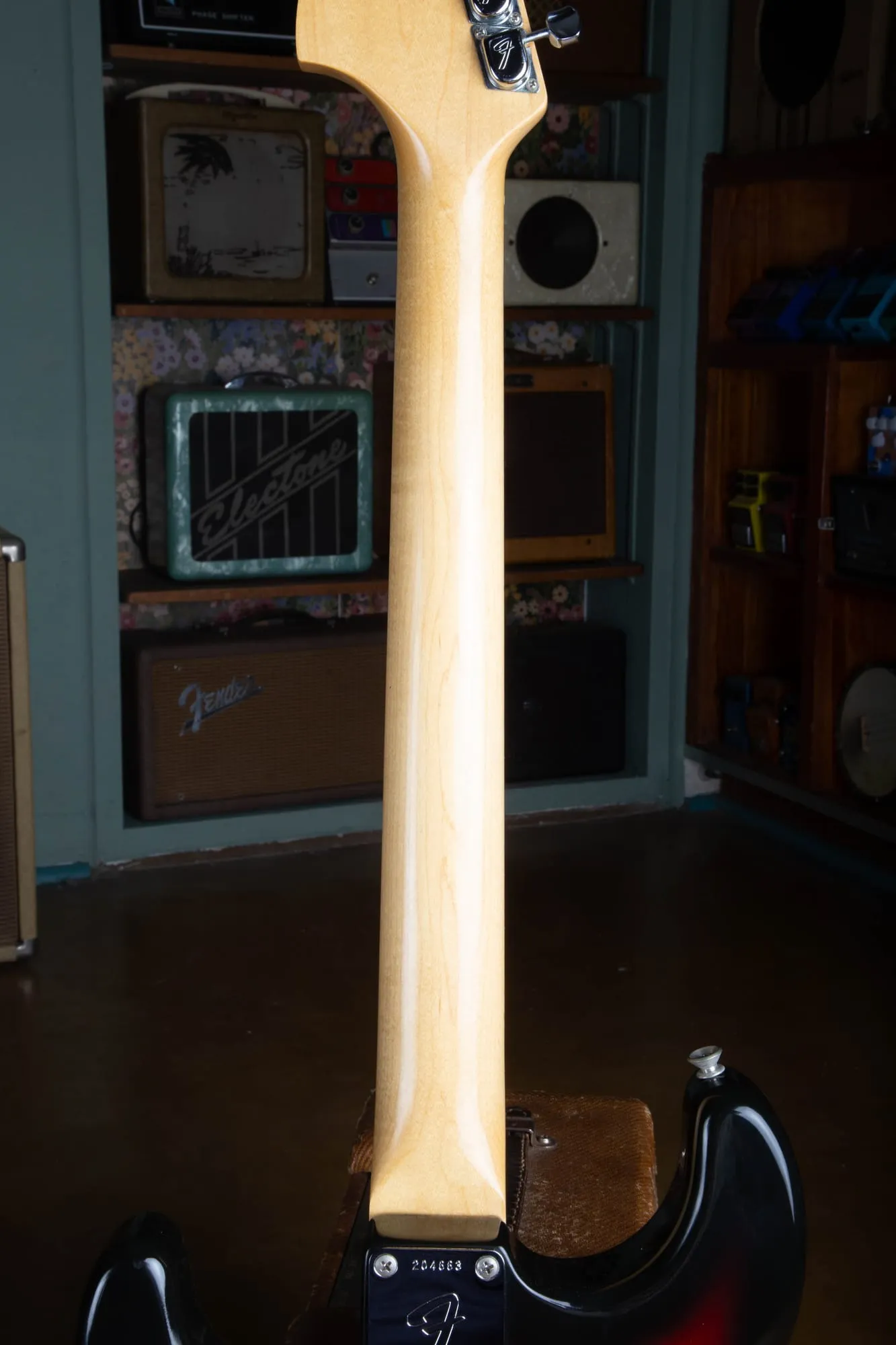Full back of a 1967 Fender Stratocaster maple neck, showing a smooth one-piece maple back with no skunk stripe and no walnut plug, confirming a rosewood-board neck with a front-loaded truss rod.