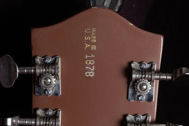 Date-coded serial number stamped on the headstock of a 1968 Gretsch guitar showing month, year digit, and unit number