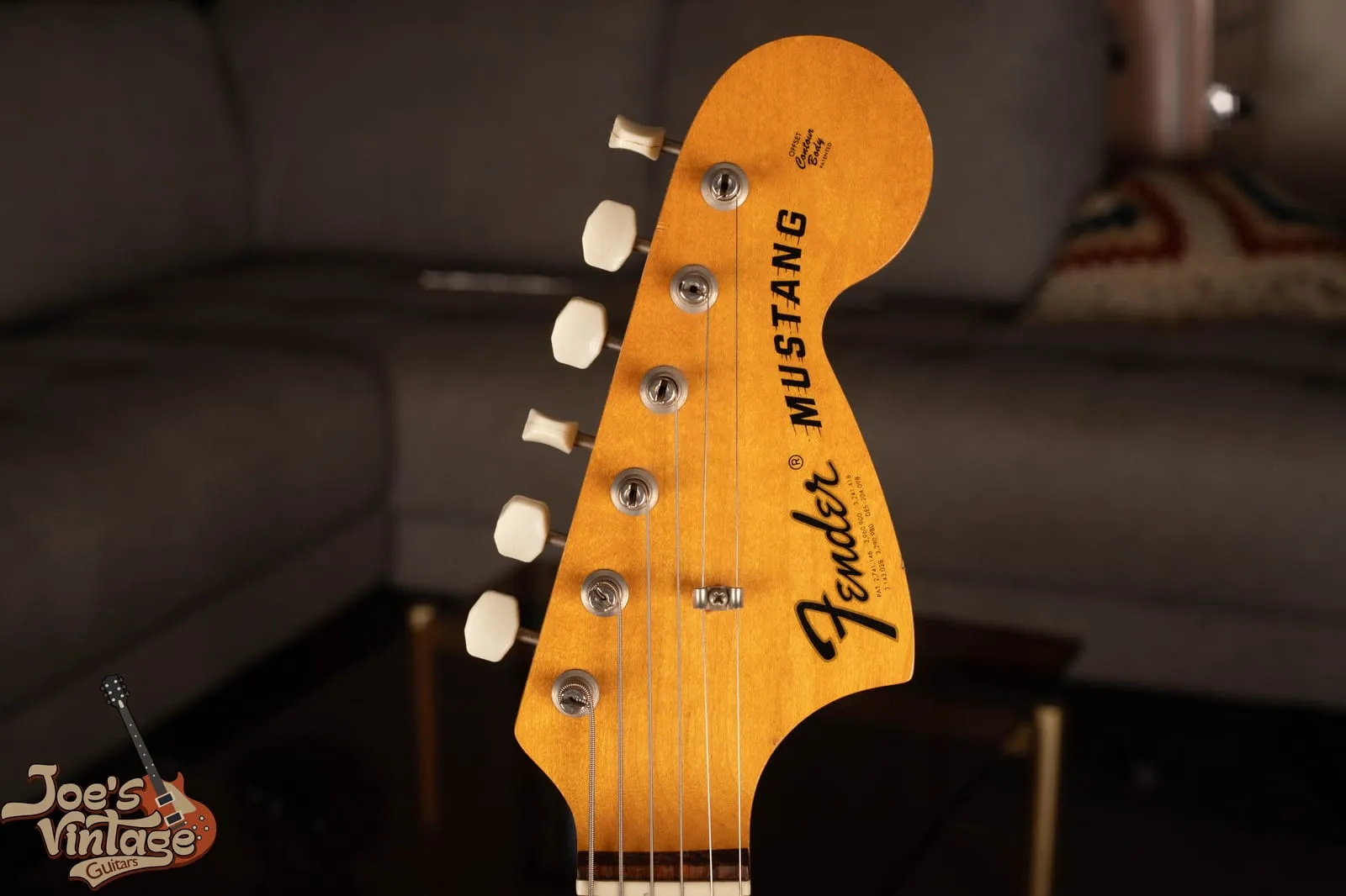 Headstock of a 1971 Fender Mustang showing the large CBS-era headstock with the bold black Fender logo and Mustang model name.