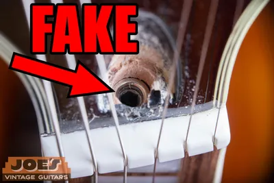 Fake Gibson truss rod showing a recessed hole for an Allen wrench where the standing brass adjustment nut should be, a counterfeit giveaway