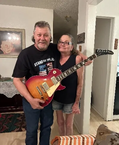 Couple receiving free guitar valuation