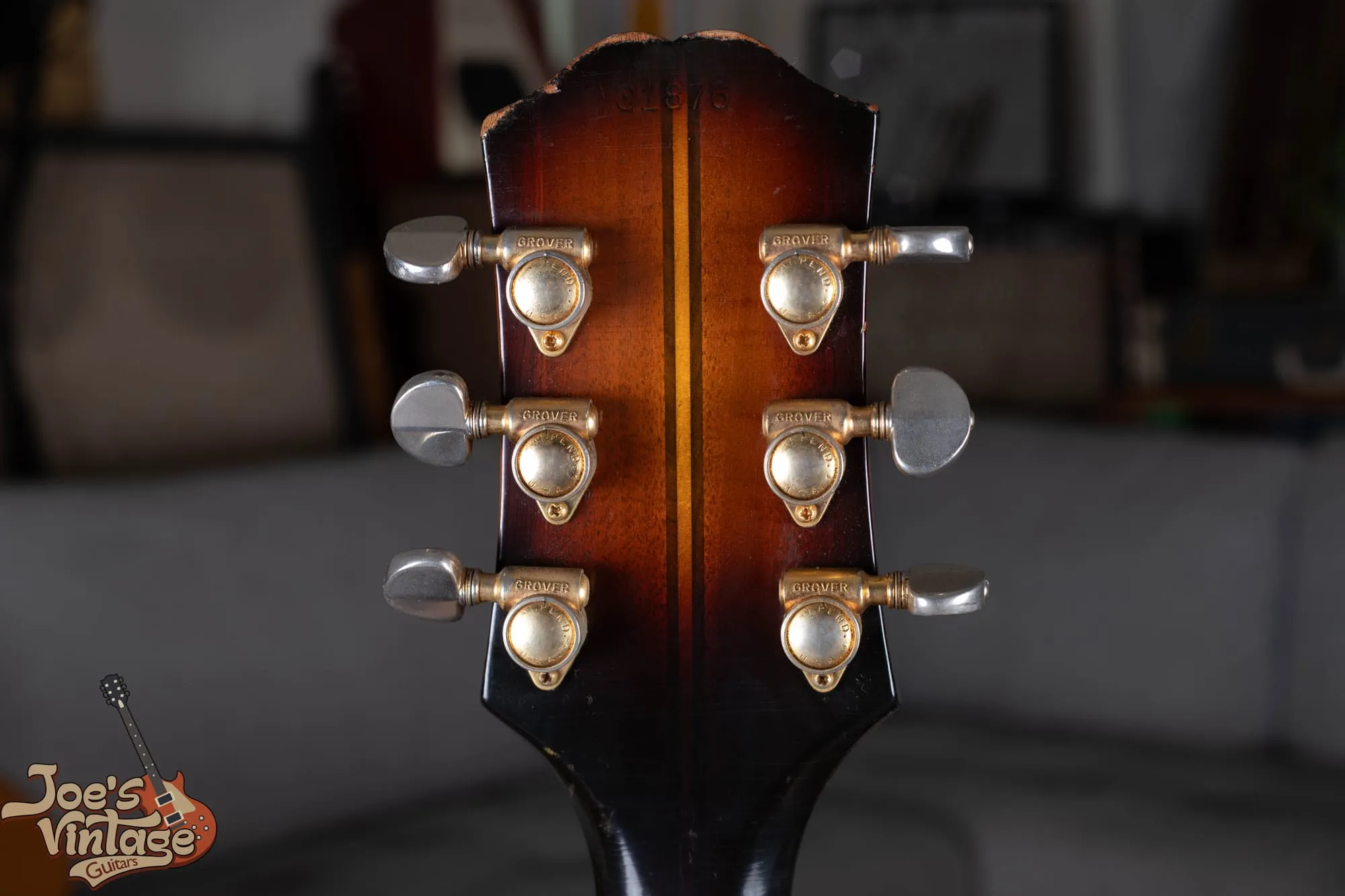 Back of a vintage Epiphone Sheraton headstock showing Grover Rotomatic tuners and the ink-stamped serial number.