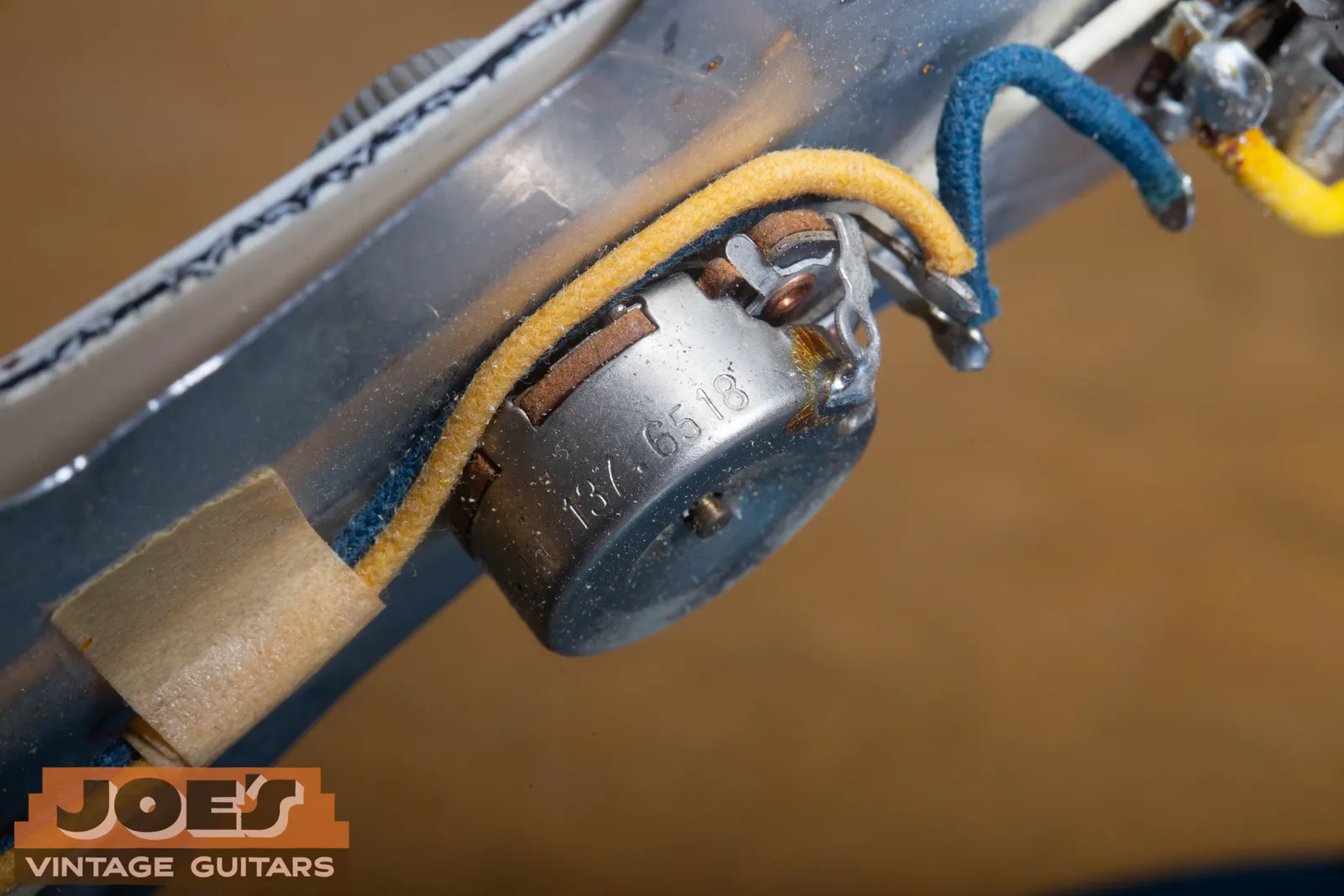 A CTS potentiometer inside a 1965 Fender, its casing stamped with the code 137 6518