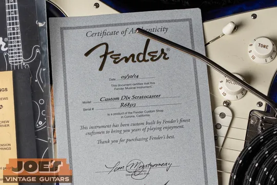 Fender Custom Shop COA for a Custom Deluxe Stratocaster with an R prefix serial. Not a Relic, not a Reissue.