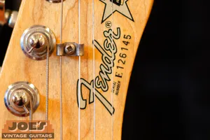 Fender E prefix serial number on the front of the headstock, 1980s
