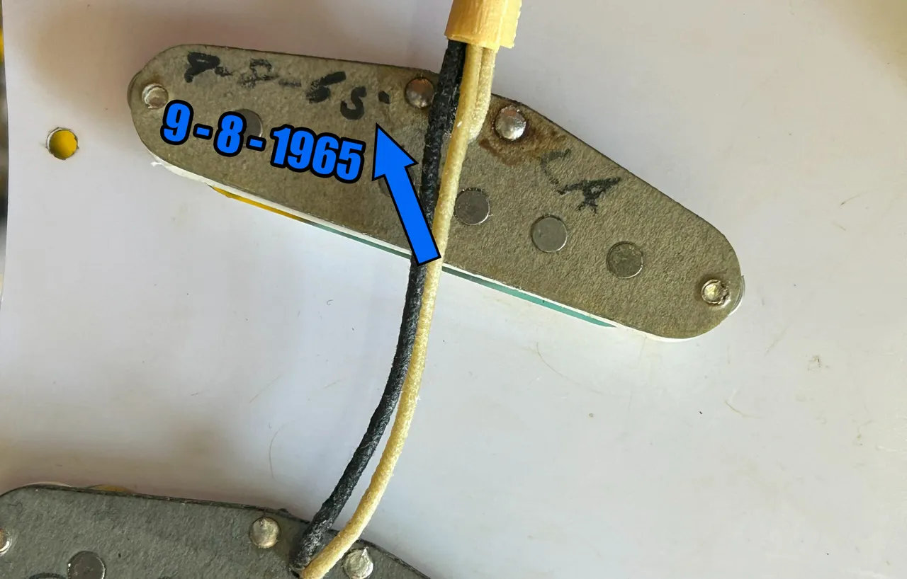 The base of a vintage Fender single-coil pickup, an inked date reading 9-8-65 for September 8, 1965