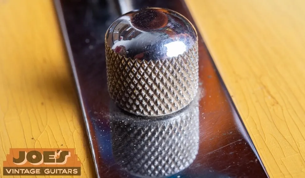 A round-top Bakelite control knob on a vintage Fender Telecaster, used before mid-1956