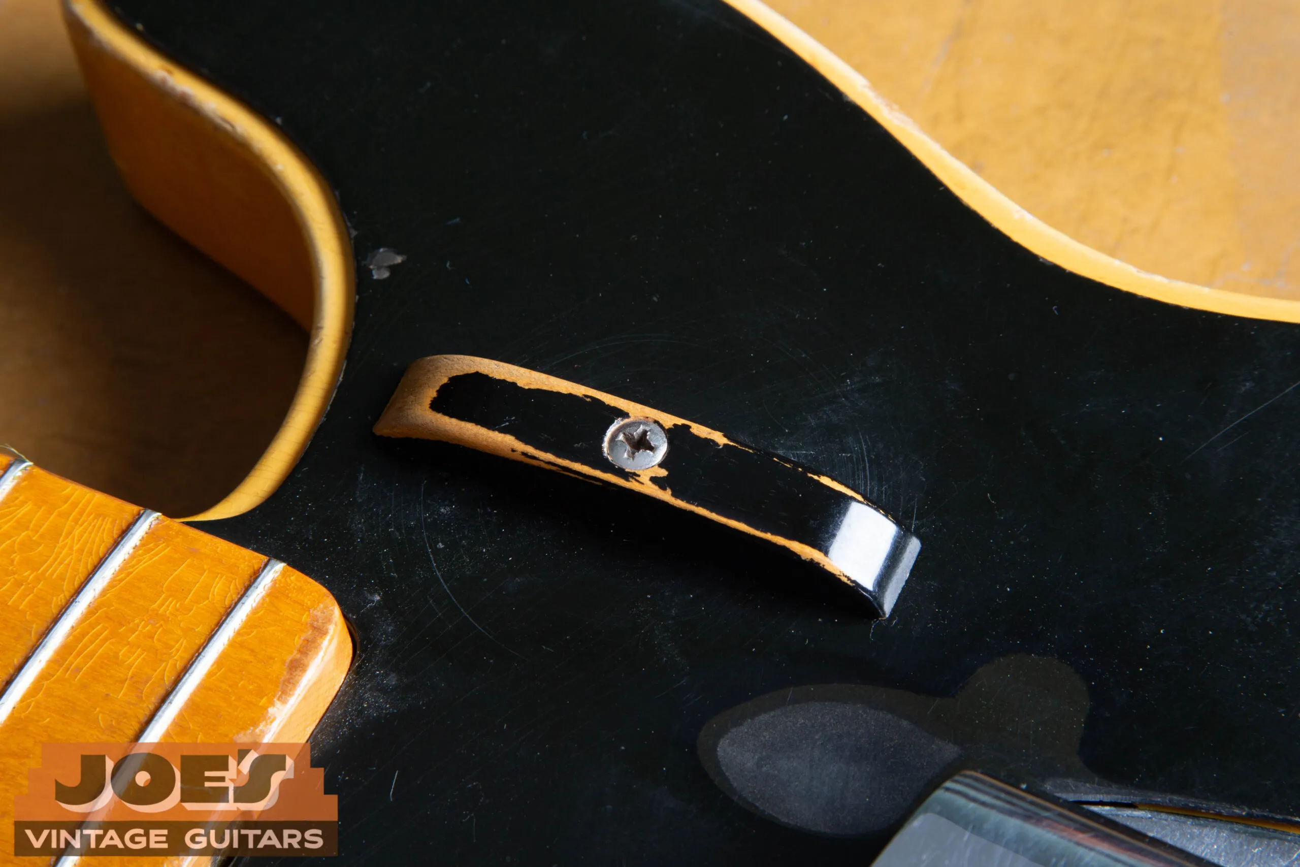 Finger rest (tug bar) on a 1952 Fender Precision Bass, wood painted black