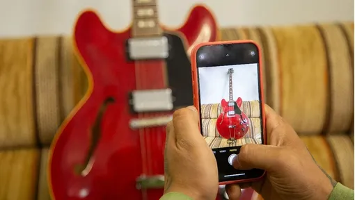 Man taking photo of cherry Gibson ES-335