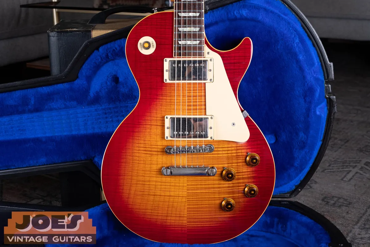 A 1984 Gibson Aldo Nova Les Paul XPL in cherry sunburst, a single-cutaway Les Paul Standard with a flamed maple top, two chrome humbuckers, and a pointed Explorer headstock, lying in a blue-lined case.