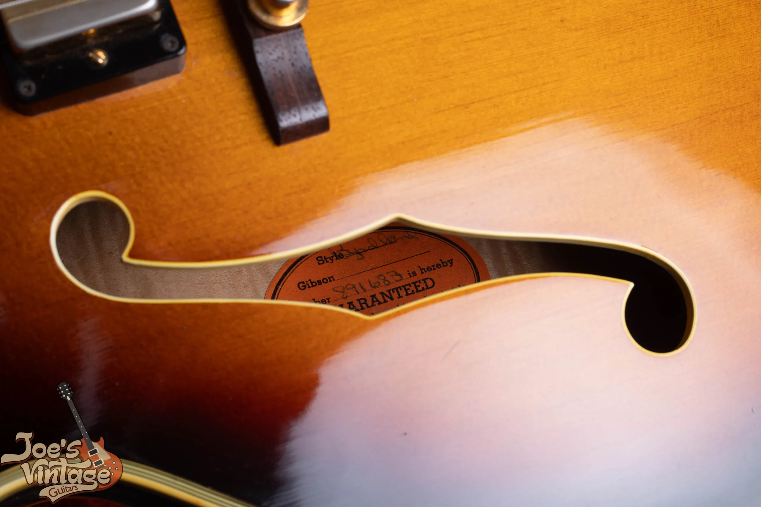 Gibson Byrdland orange oval label inside body showing A-series serial number, used 1955 to 1969 pre-Norlin era
