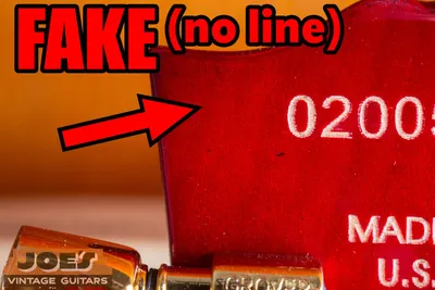 Back of a fake Gibson headstock with no wing seam line, indicating a one-piece counterfeit neck