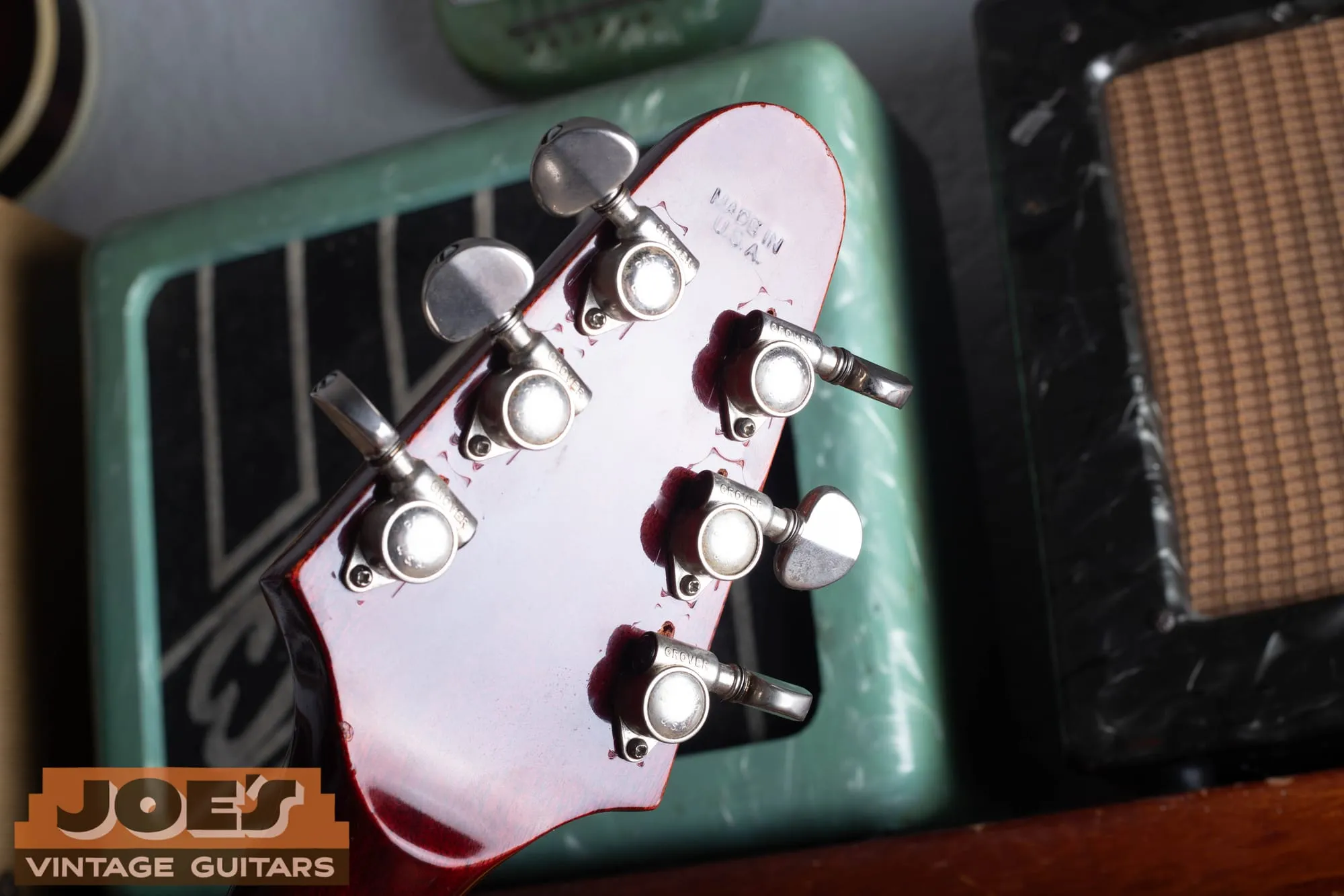 Close-up of the Grover tuners on the headstock of a 1971 Gibson Flying V Medallion, three per side, with metal buttons stamped Grover.