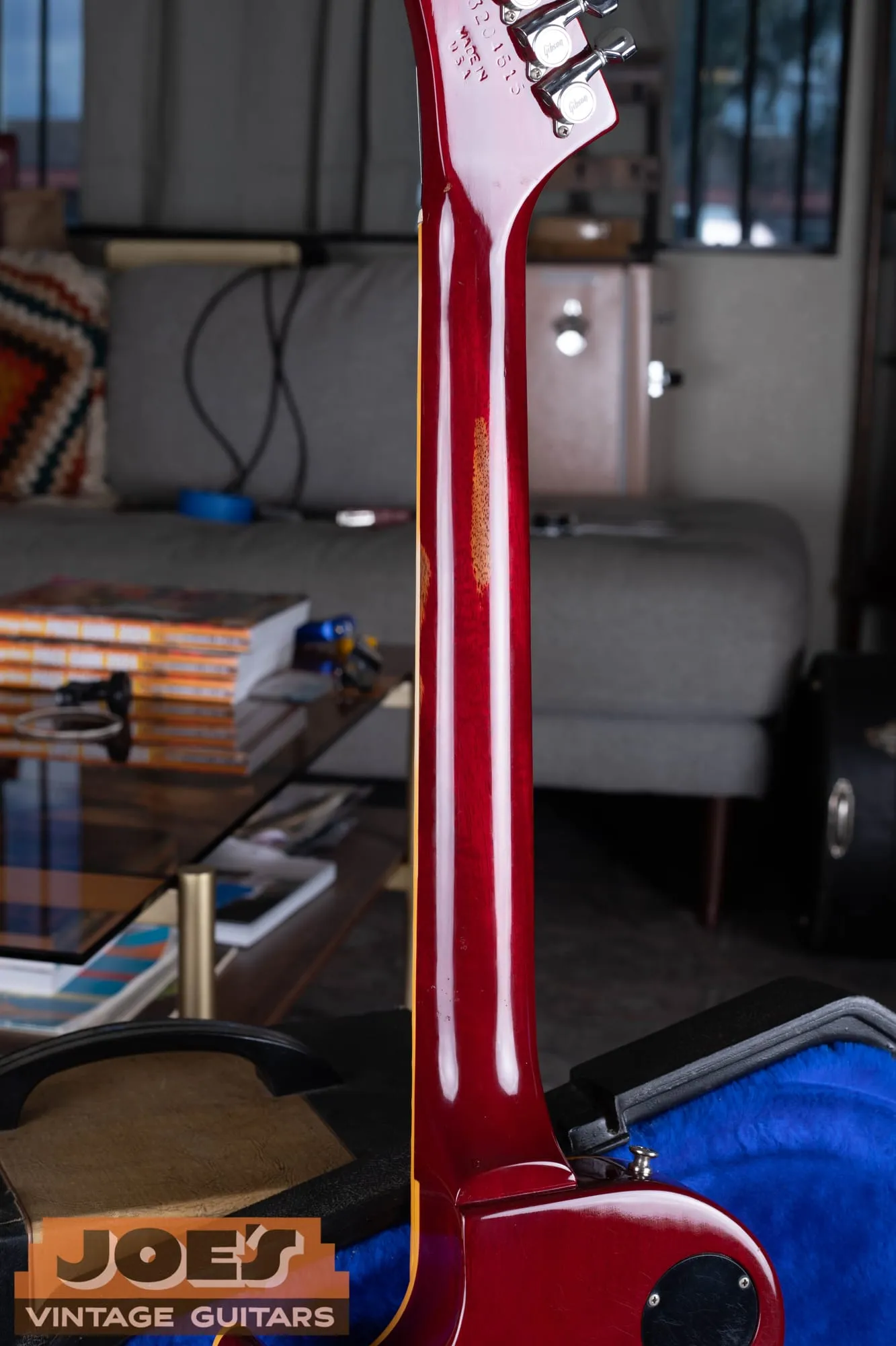 Close-up of the impressed eight-digit serial number and Made in U.S.A. stamp on the back of a Gibson Les Paul XPL headstock in cherry finish.