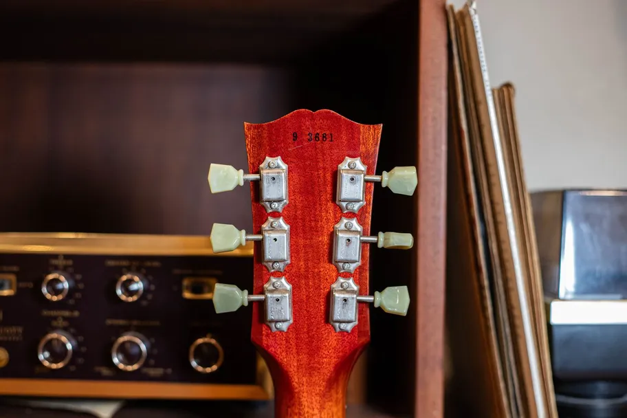 Ink-stamped serial number on the back of the headstock of a Gibson R9 Les Paul Historic Reissue, where the first digit indicates the model year being reissued, not the production year