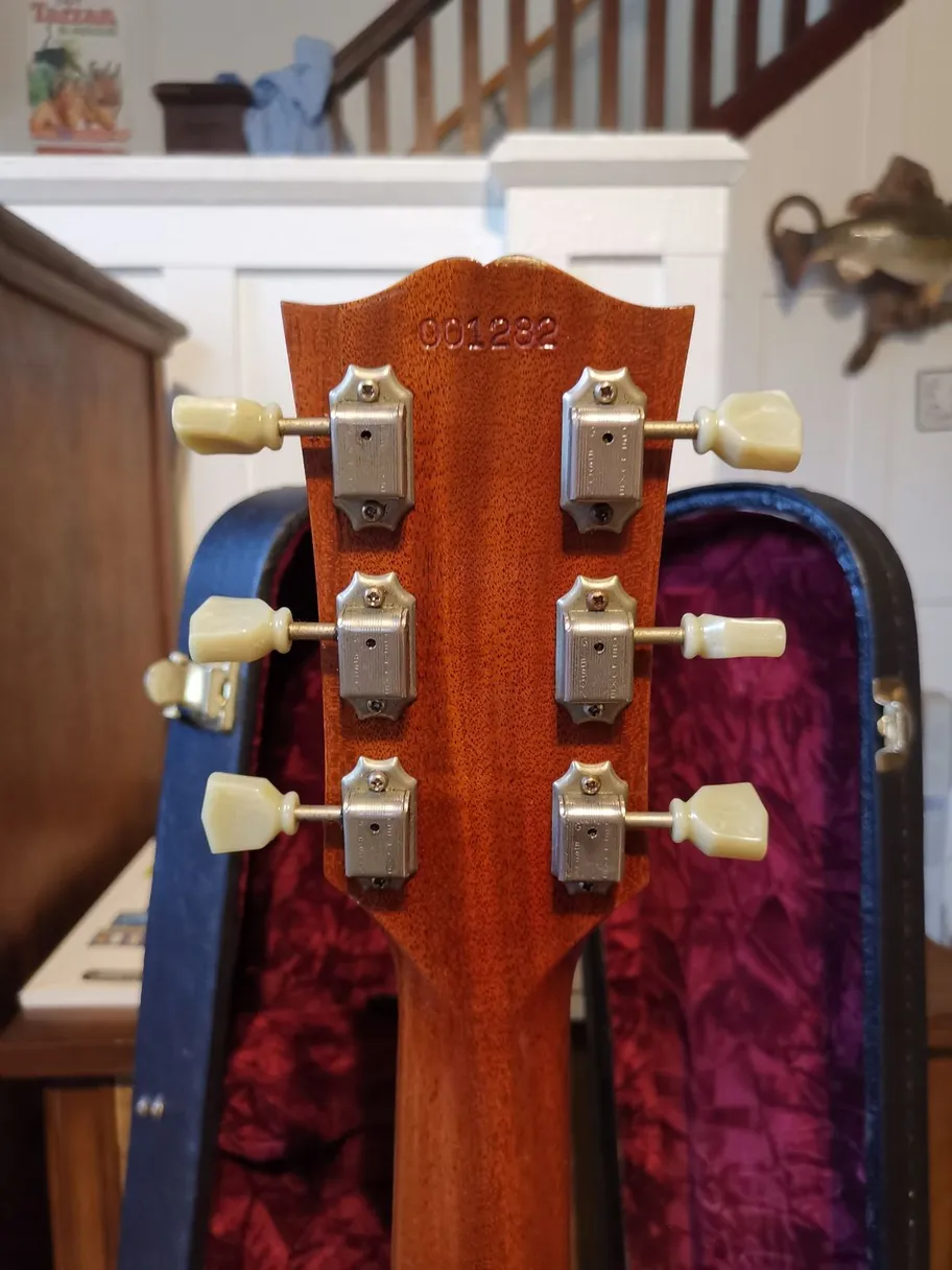 Impressed serial number on the back of the headstock of a Gibson SG Historic Reissue Custom Shop guitar, physically pressed into the wood rather than ink-stamped