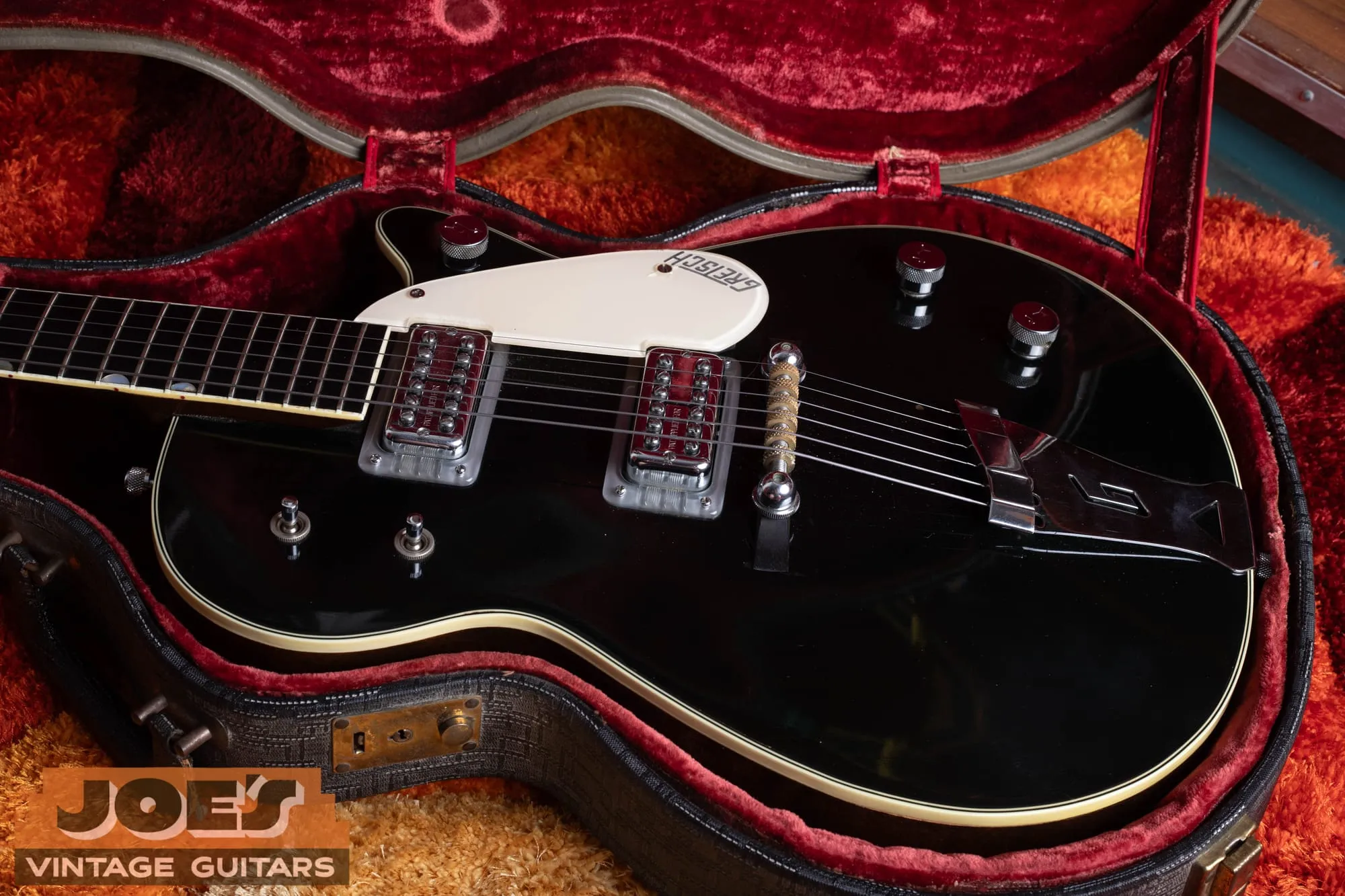 Close-up of two Filter’Tron humbucker pickups with Patent Applied For covers and the controls of a black Gretsch Duo Jet.