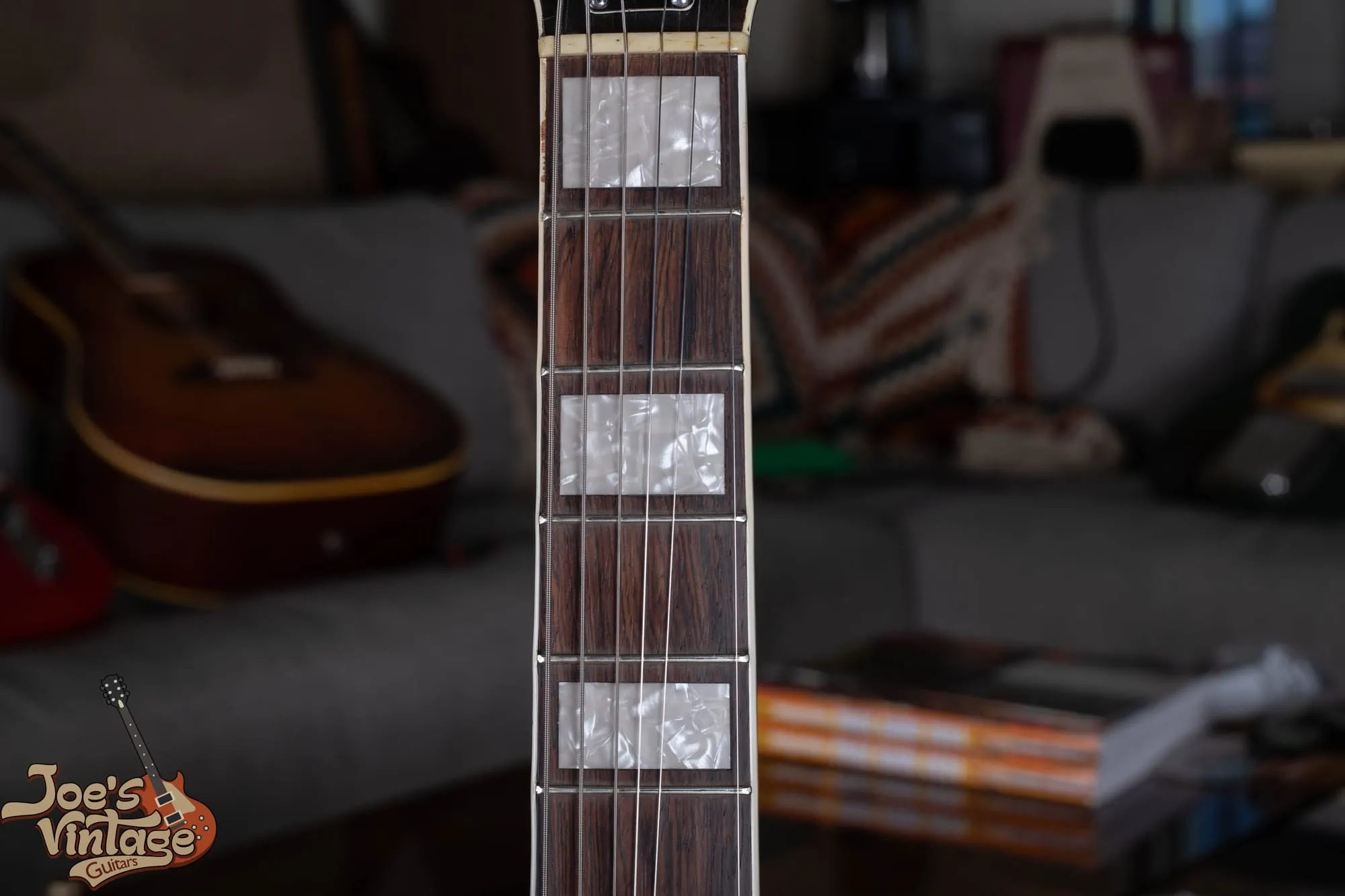Close-up of pearloid block inlays on the bound rosewood fingerboard of a vintage Gretsch Jet Fire Bird.