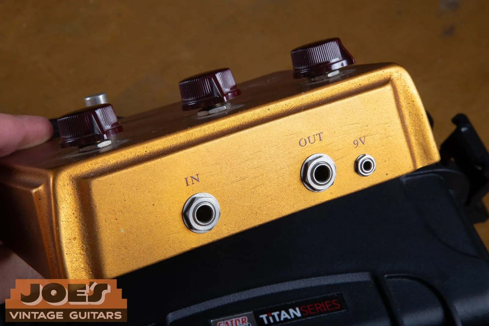 The rear jack panel of a Klon Centaur showing IN and OUT quarter inch jacks and a small 3.5mm jack labeled 9V.