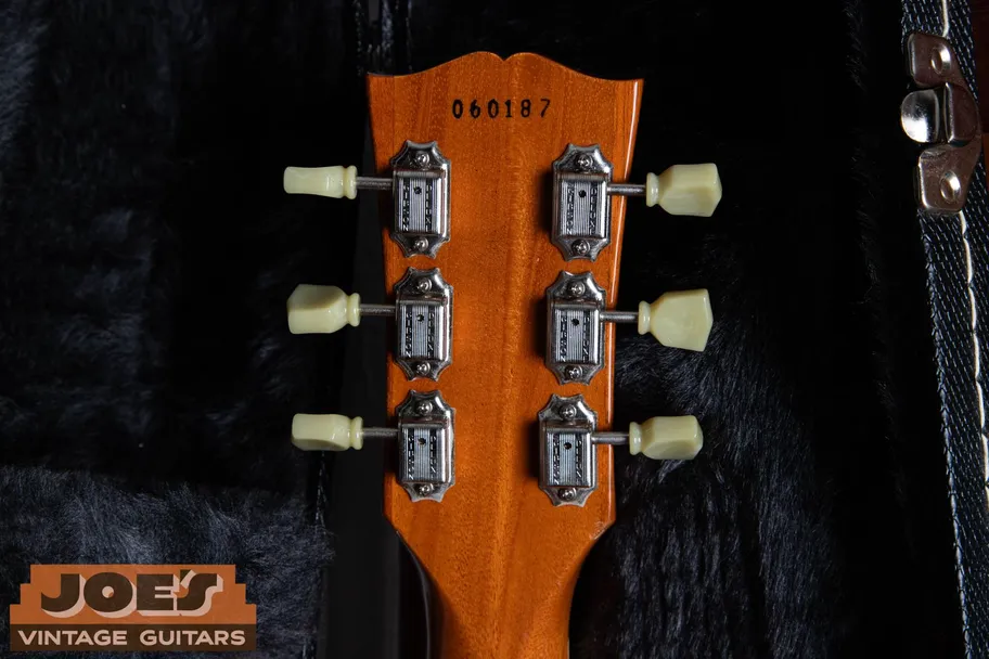 Ink stamped serial number on the back of the headstock of a Gibson Les Paul Classic, a reissue-style stamp that differs from the authentic vintage 1950s ink-stamp font