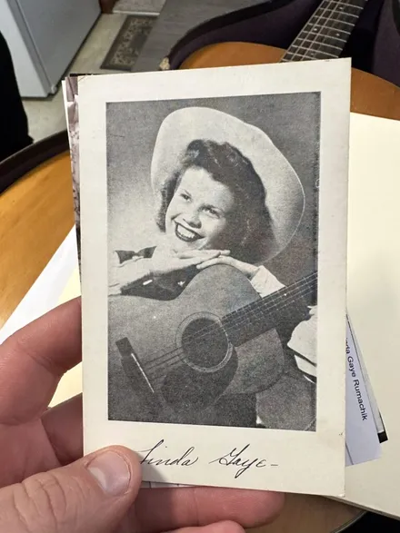 Black and white 1950s historical photo of Linda playing her vintage Martin 0-18 on the radio. Joe’s Vintage Guitars specializes in buying Martin guitars with documented history and provenance.