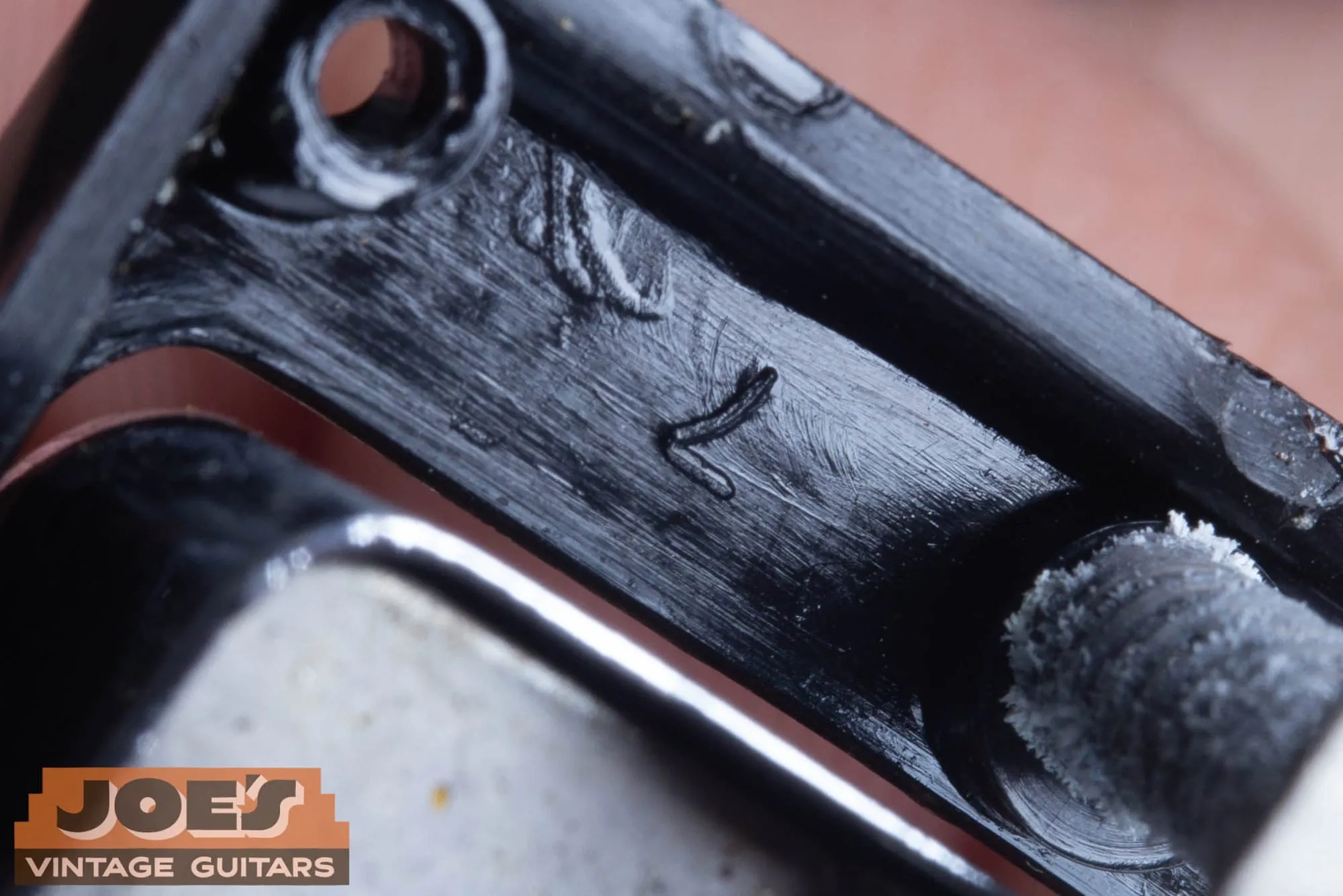 Single stamped figure on the underside of a vintage Gibson pickup ring.